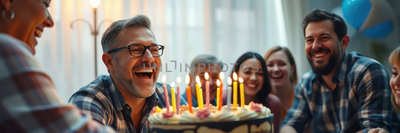 A group of friends enjoys a lively birthday celebration indoors, sharing laughter and smiles around a beautifully decorated cake with candles lit, creating a warm atmosphere.