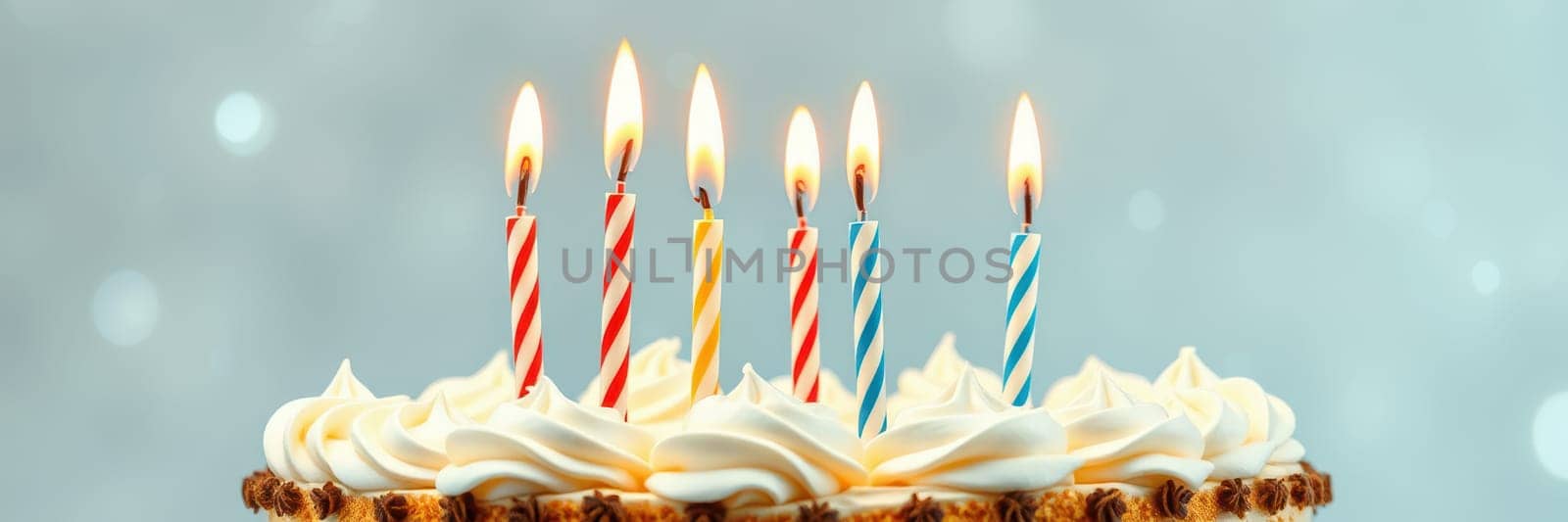 A delightful cake is adorned with six colorful candles, each aglow, set against a soft, shimmering background. This vibrant display captures the essence of celebration.