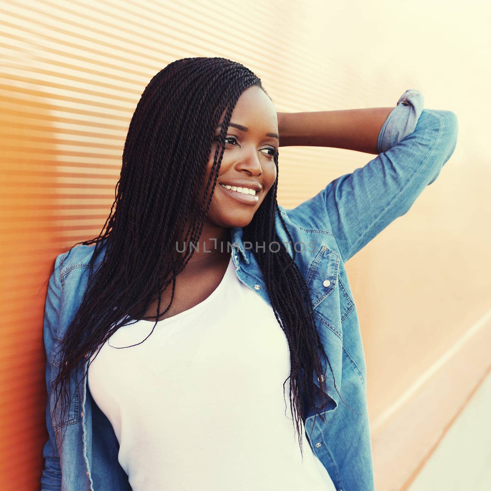 Portrait beautiful happy smiling african woman in city, profile view