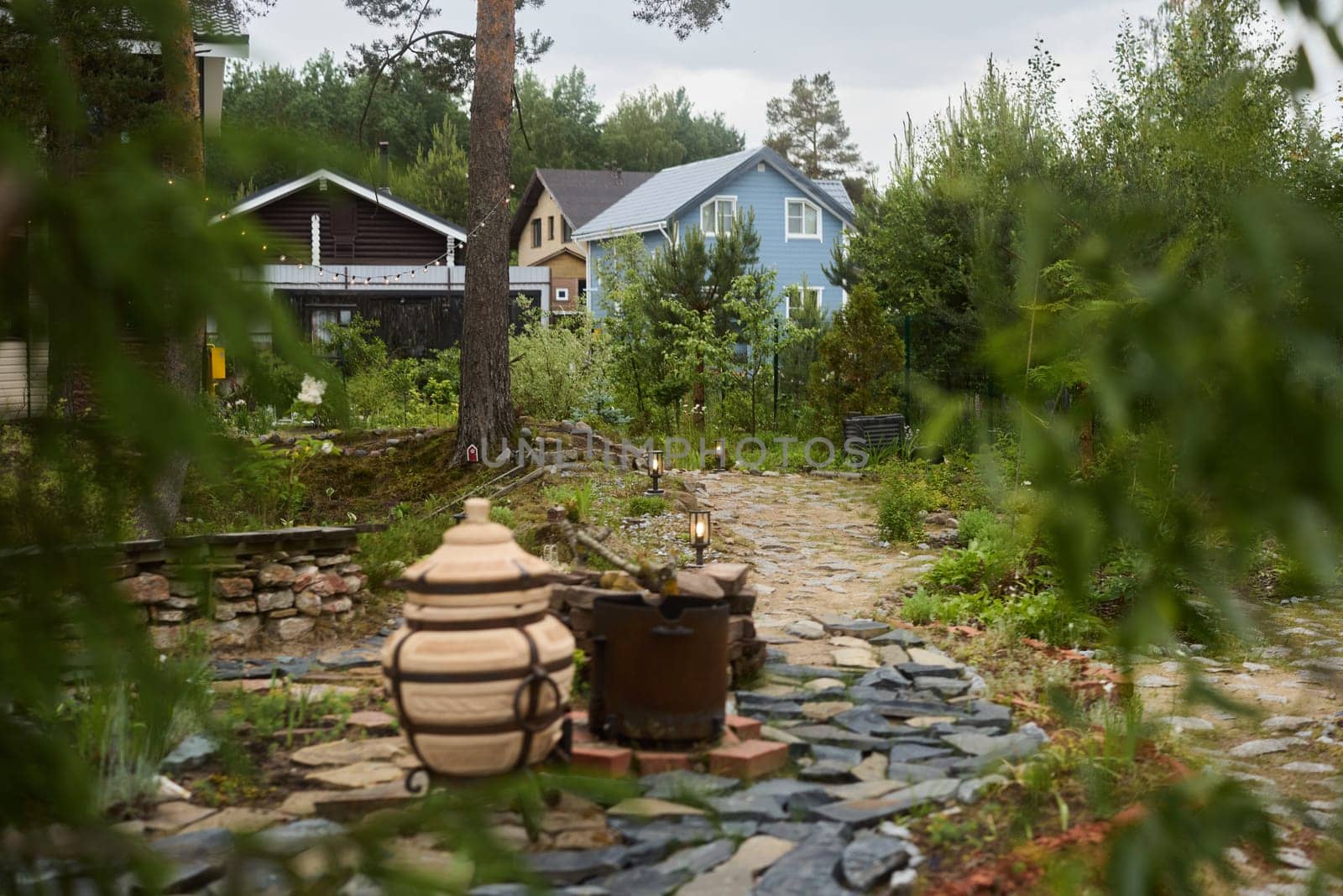 A beautifully scenic garden filled with rustic elements and cozy homes, all surrounded harmoniously by nature