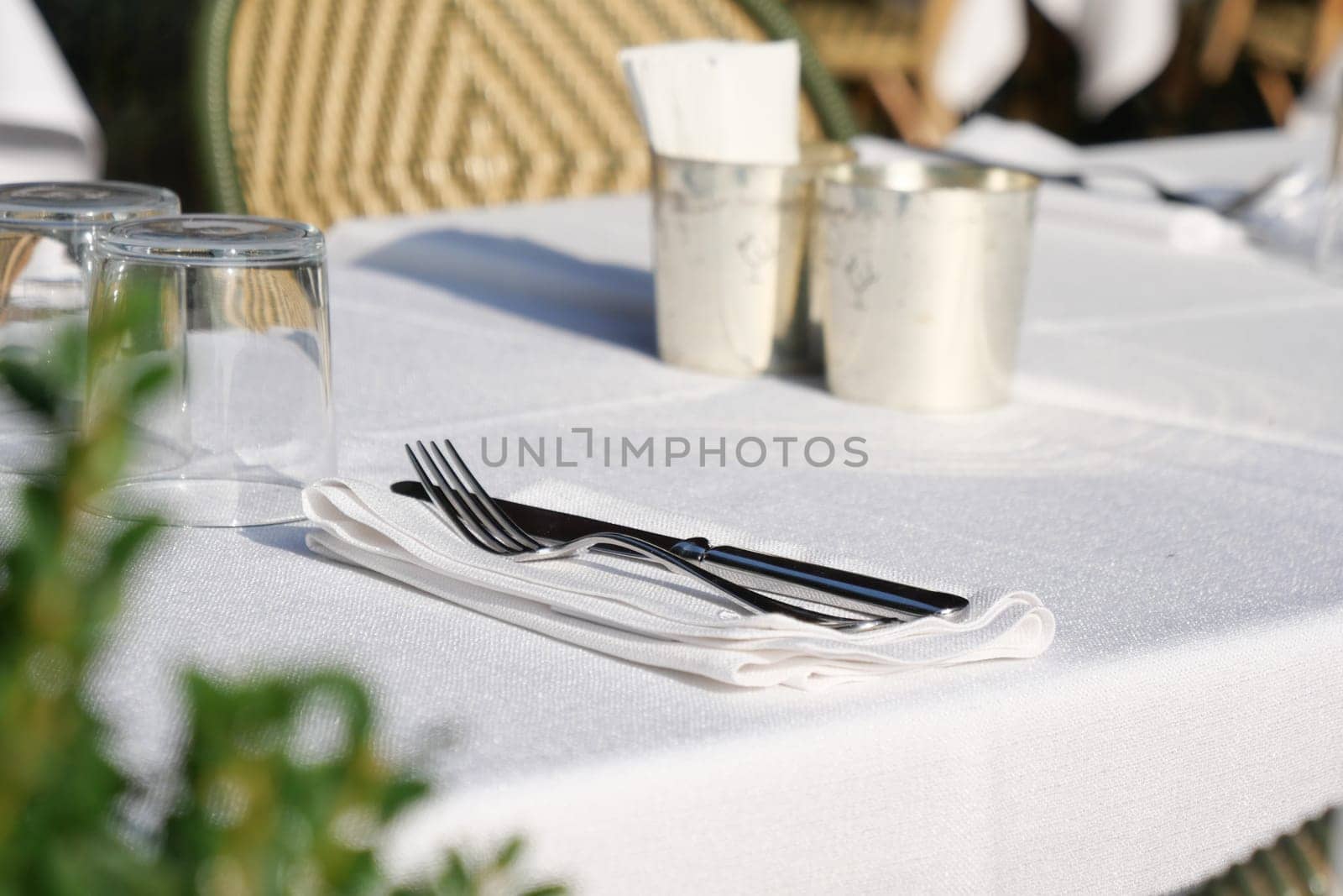 A beautifully arranged table featuring elegant silver cutlery and pristine white linens