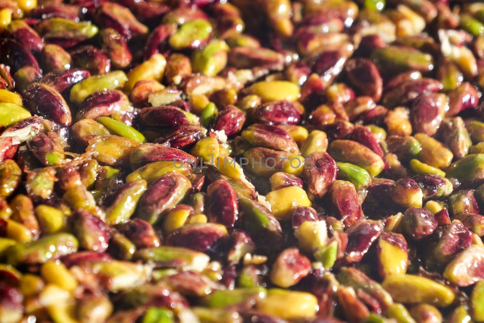 A detailed close-up of various fresh pistachios showcasing their natural colors and textures.