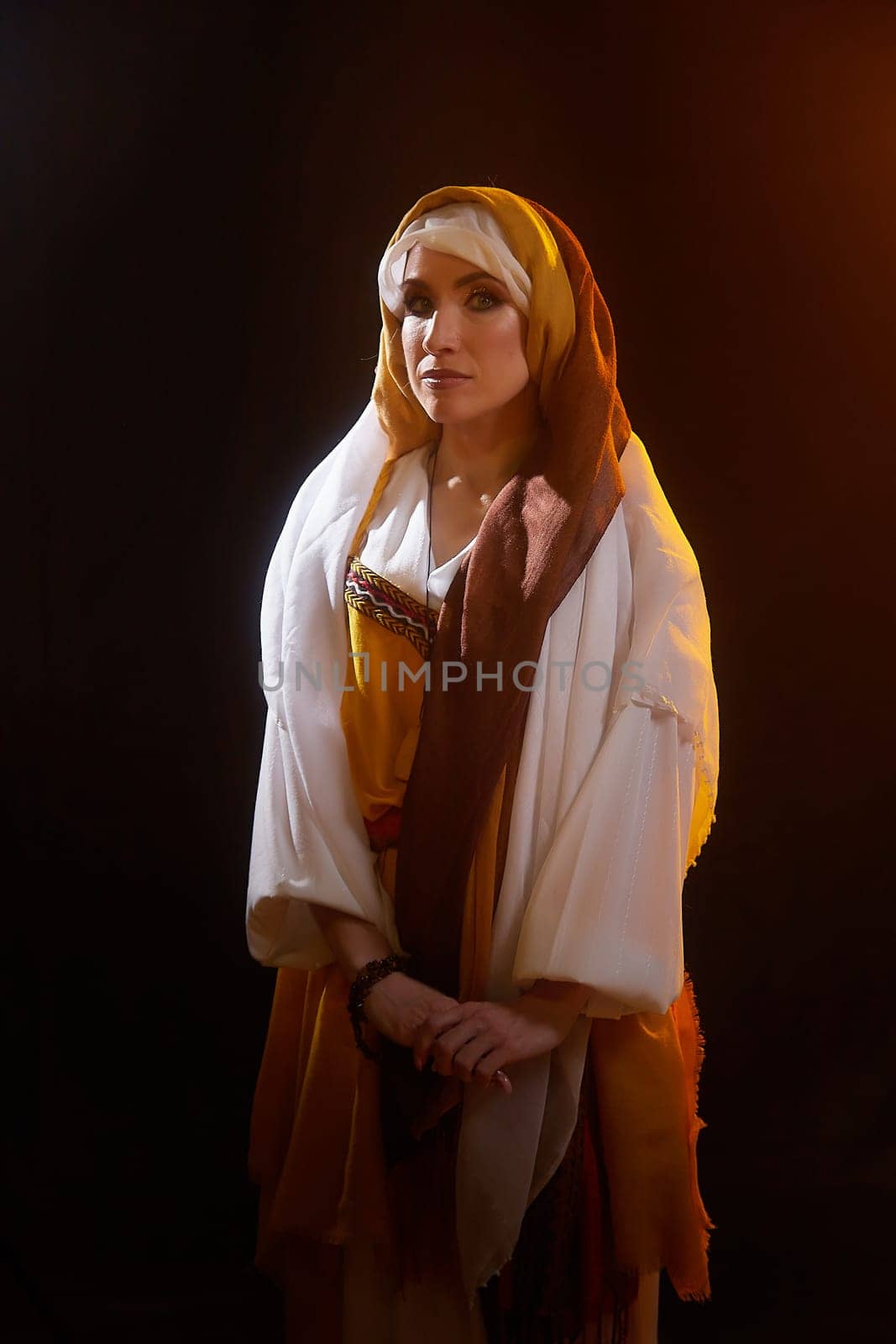 A girl is dressed in stylized national clothing, embodying Rebekah from the Christian Bible in an artistic setting.