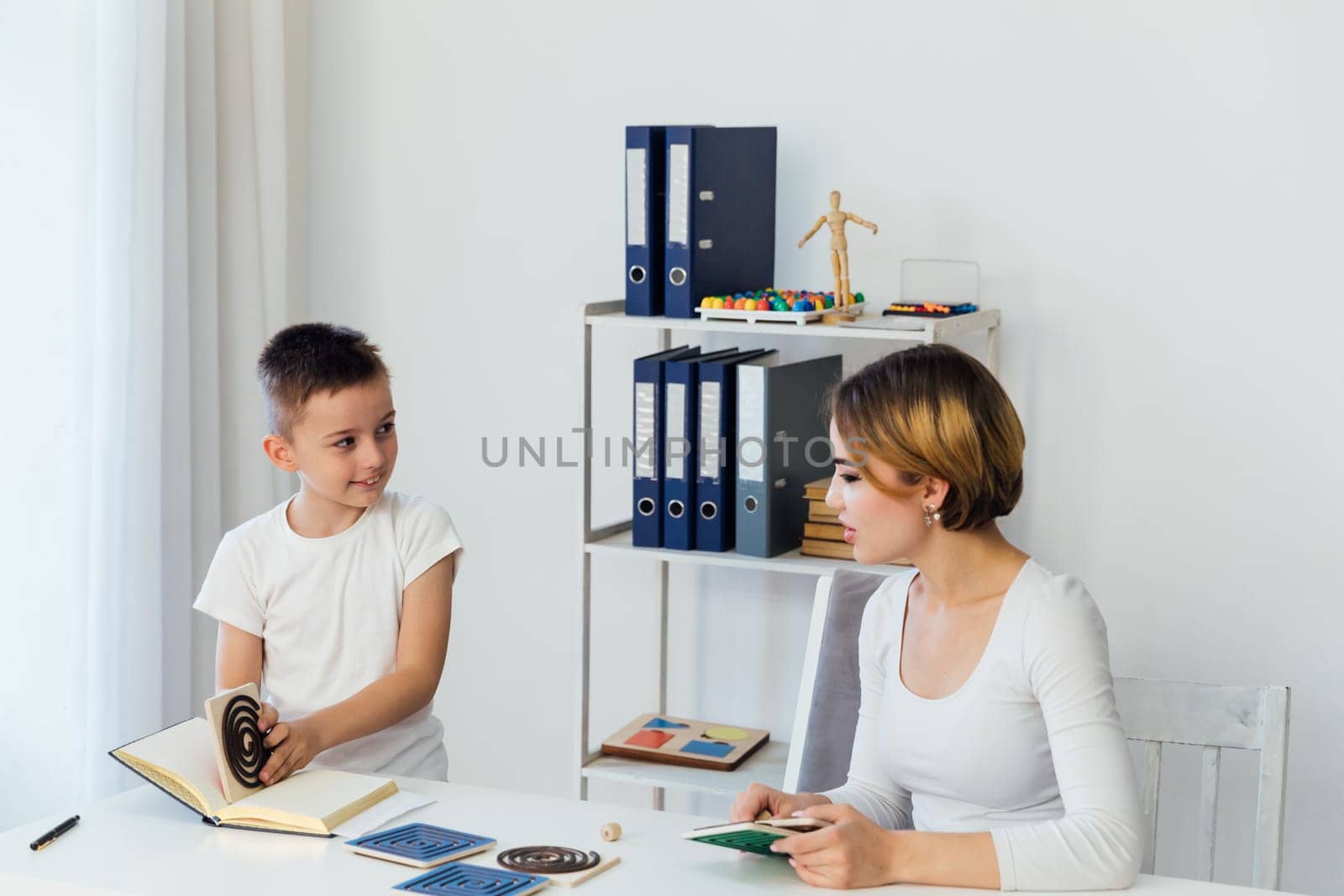 Teacher Playing Educational Games With Boy