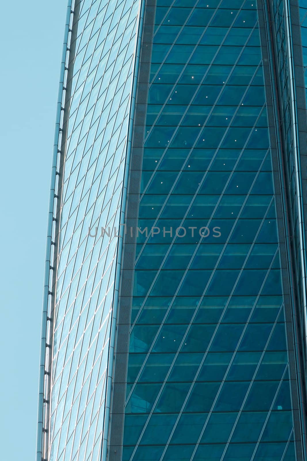 A stunning closeup view of a towering skyscrapers reflective glass facade, beautifully showcasing modern architecture