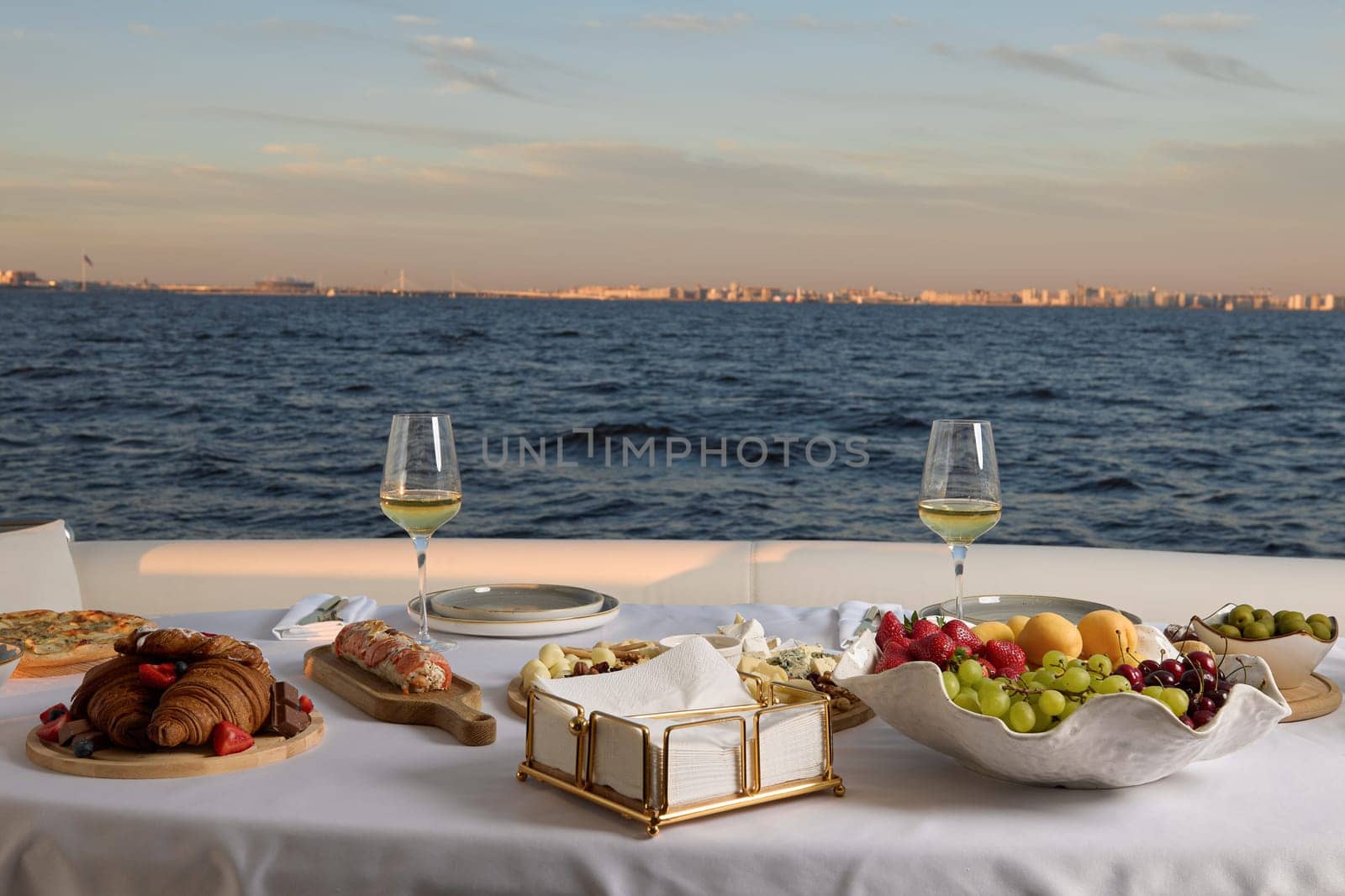 A luxurious dining setup on a beautiful yacht, featuring exquisite gourmet food and stunning ocean views