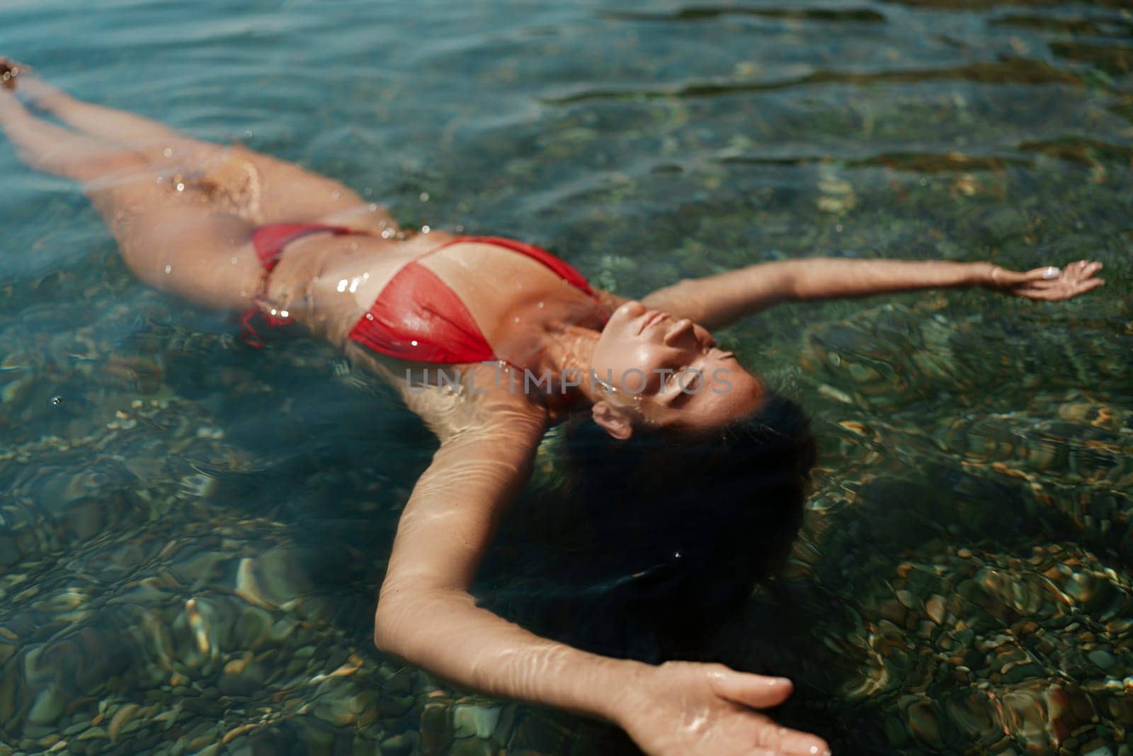 Happy woman sea relaxing floating in transparent sea water on summer holiday. Travel leisure recreation lifestyle, female in nature