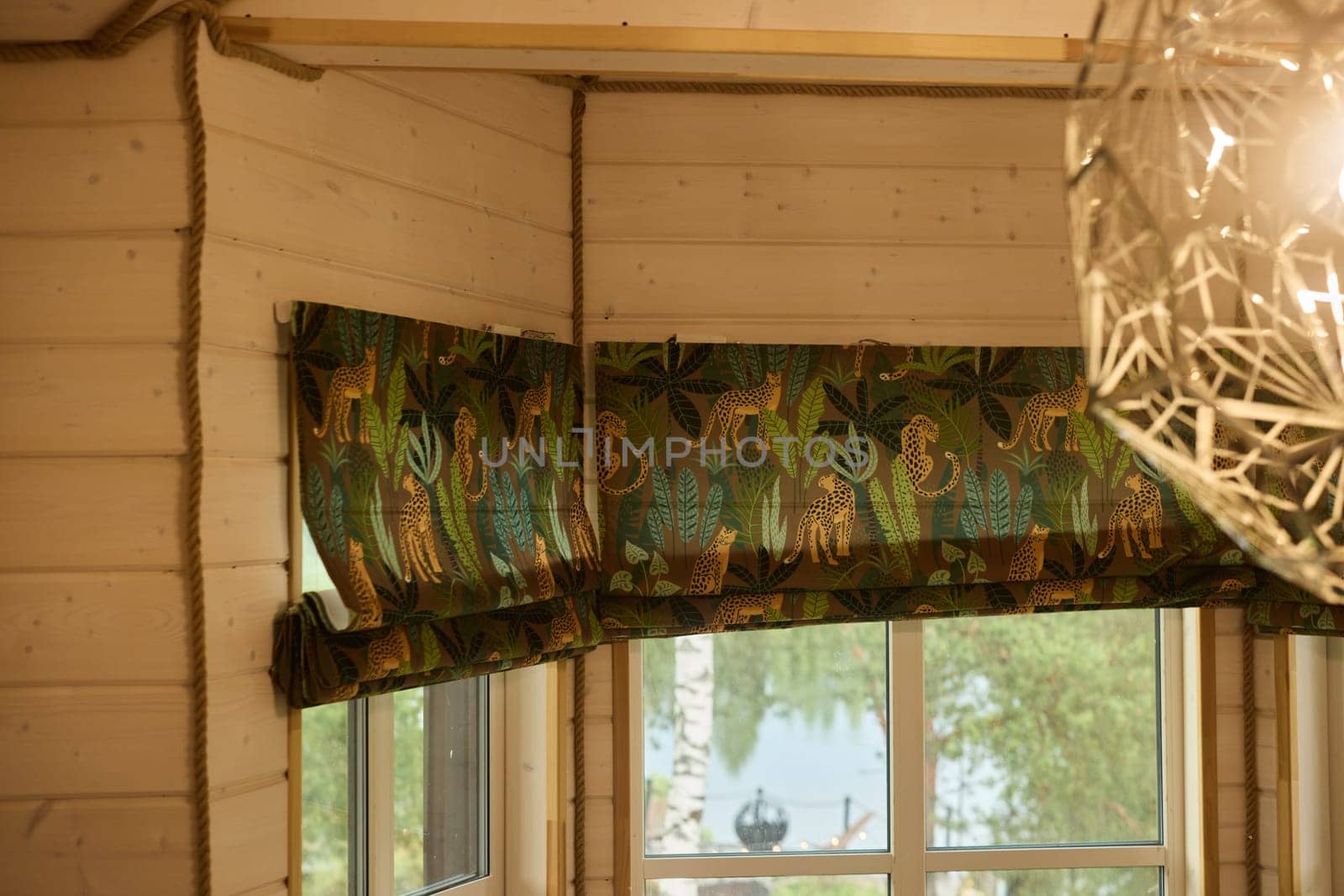 A beautifully crafted window treatment adorned with a vibrant and colorful pattern inspired by natures beauty