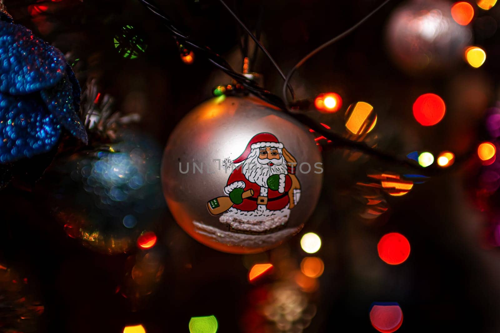 Beautiful festive decorations on the Christmas tree. Close-up. Beautiful Christmas background. The concept of decorations and decor for the new year. New Year's Card 2025. High quality photo