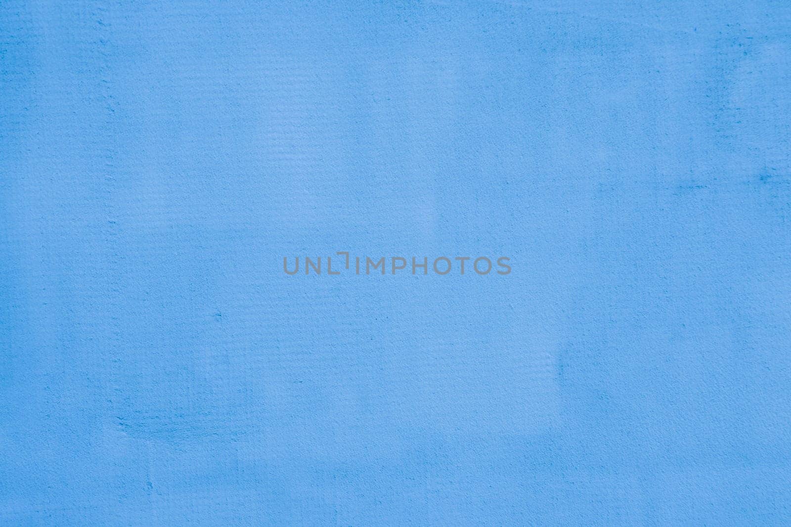 Blue stone wall background. Worn blue plaster on a concrete wall.