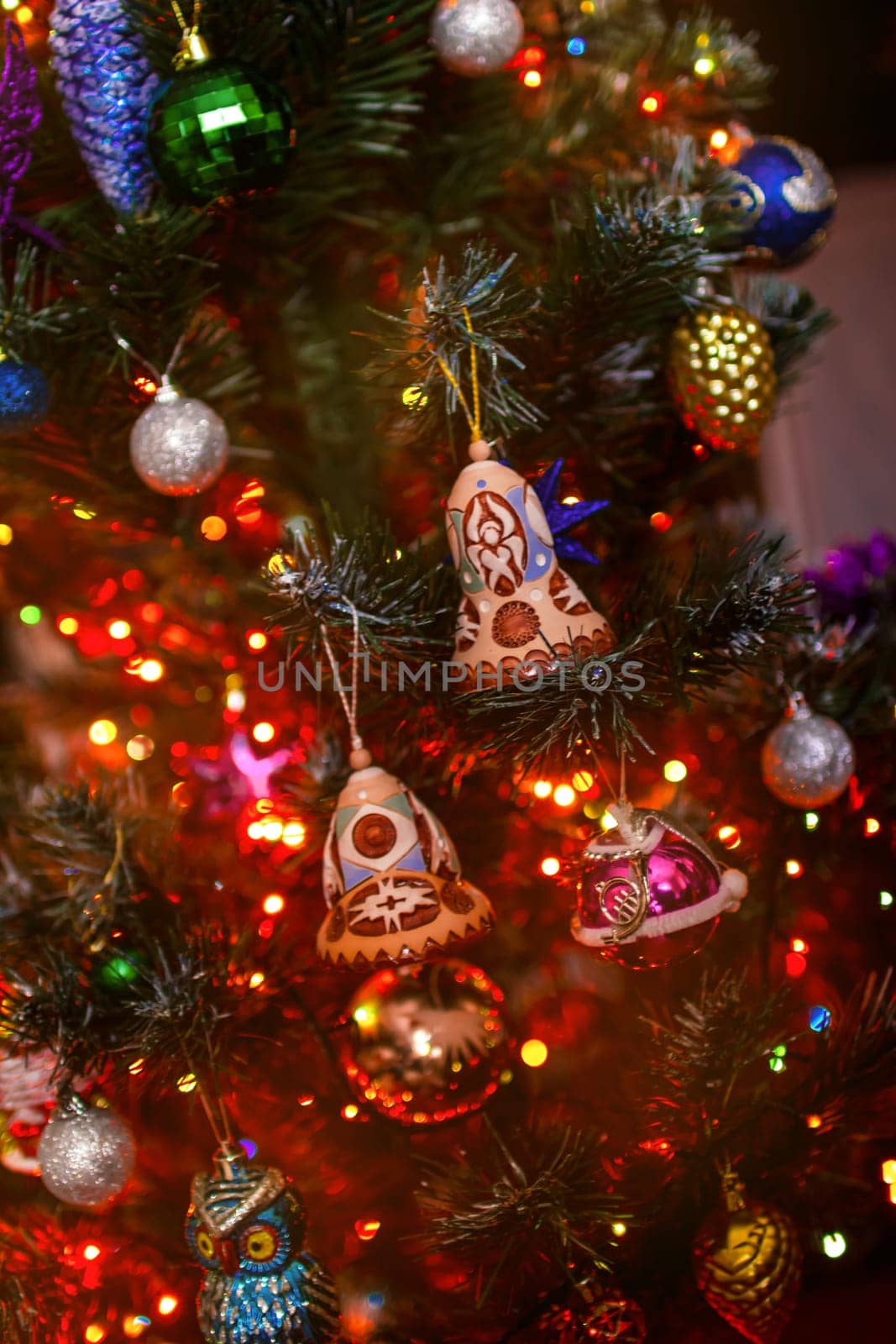 Beautiful festive decorations on the Christmas tree. Close-up. Beautiful Christmas background. The concept of decorations and decor for the new year. New Year's Card 2025. High quality photo