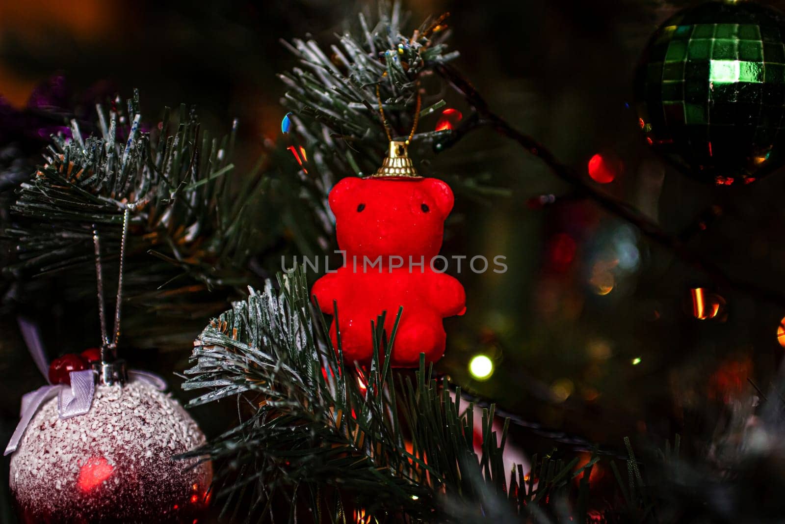 Beautiful festive decorations on the Christmas tree. Close-up. Beautiful Christmas background. The concept of decorations and decor for the new year. New Year's Card 2025. High quality photo