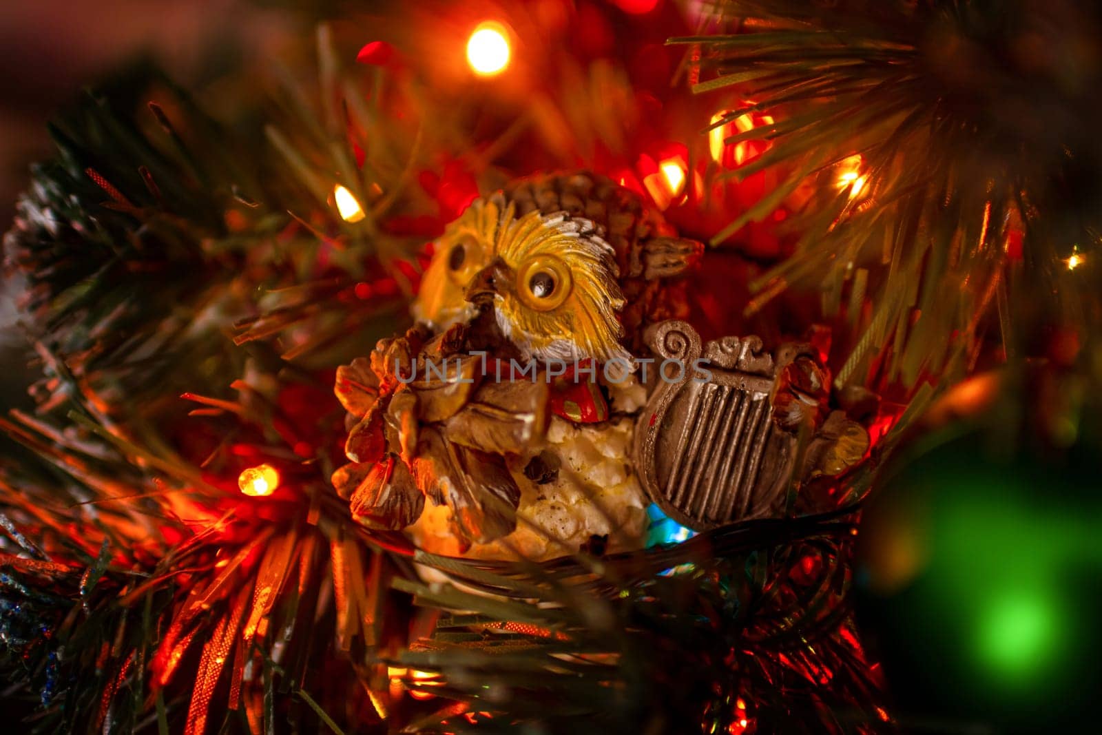 Beautiful festive decorations on the Christmas tree. Close-up. Beautiful Christmas background. The concept of decorations and decor for the new year. New Year's Card 2025. High quality photo