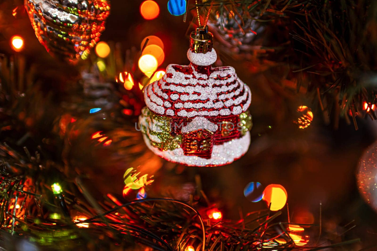 Beautiful festive decorations on the Christmas tree. Close-up. Beautiful Christmas background. The concept of decorations and decor for the new year. New Year's Card 2025. High quality photo
