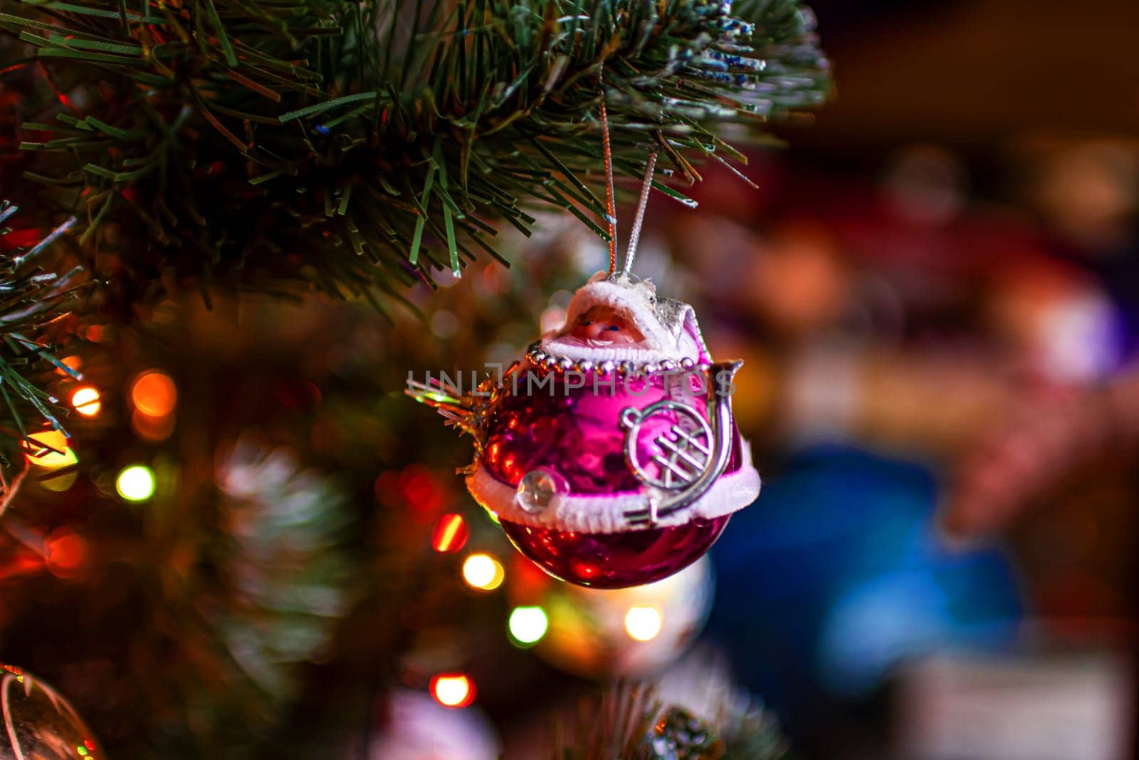 Beautiful festive decorations on the Christmas tree. Close-up. Beautiful Christmas background. The concept of decorations and decor for the new year. New Year's Card 2025. High quality photo