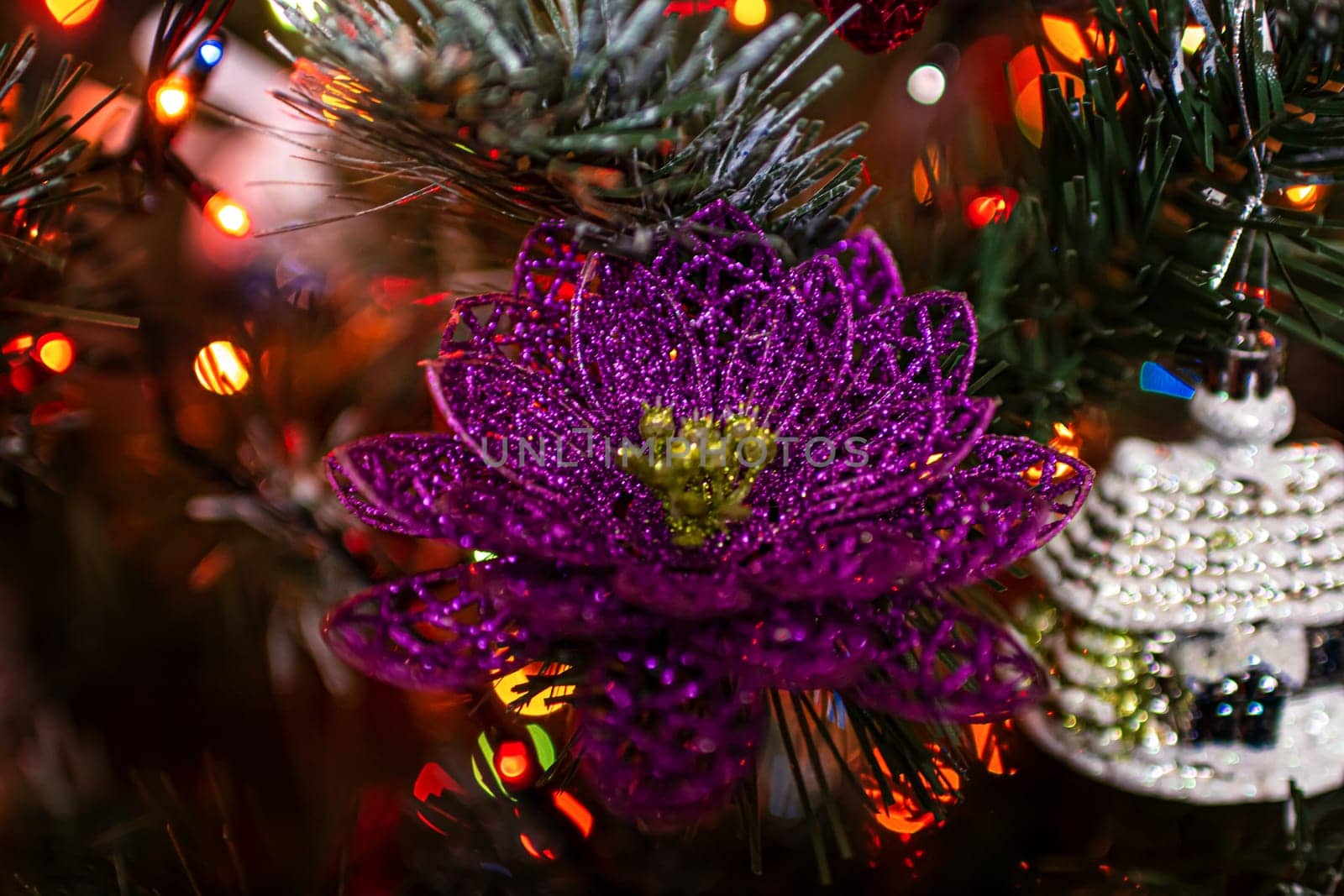 Beautiful festive decorations on the Christmas tree. Close-up. Beautiful Christmas background. The concept of decorations and decor for the new year. New Year's Card 2025. High quality photo