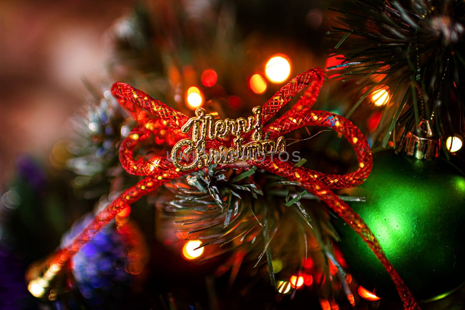 Beautiful festive decorations on the Christmas tree. Close-up. Beautiful Christmas background. The concept of decorations and decor for the new year. New Year's Card 2025. High quality photo