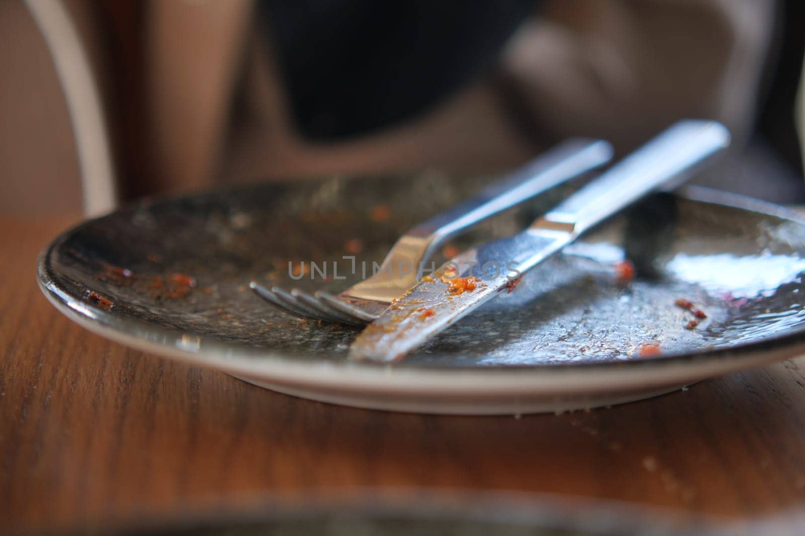 An empty dirty plate with a fork..