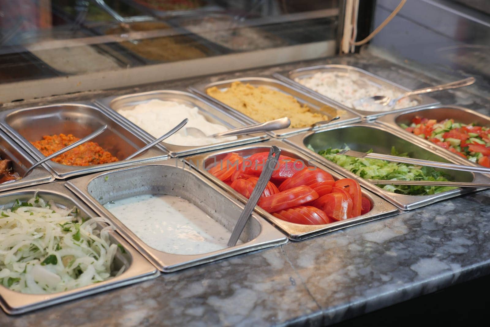 A vibrant and colorful display of fresh toppings is ideal for salads, wraps, and many other dishes