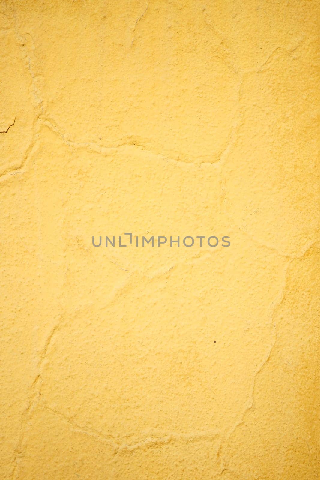 A vibrant yellow wall texture ideal for backgrounds and graphic designs for creativity