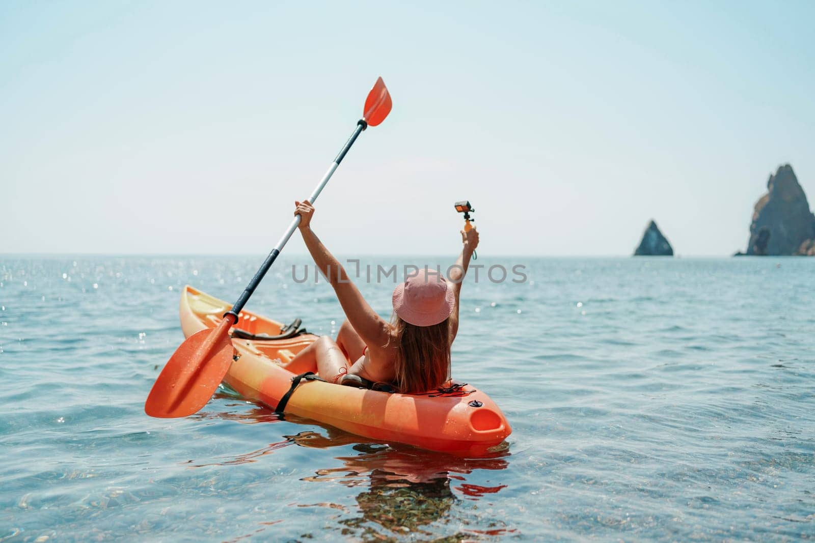 Kayak sea woman. Happy attractive woman with long hair in red swimsuit, swimming on kayak. Summer holiday vacation and travel concept
