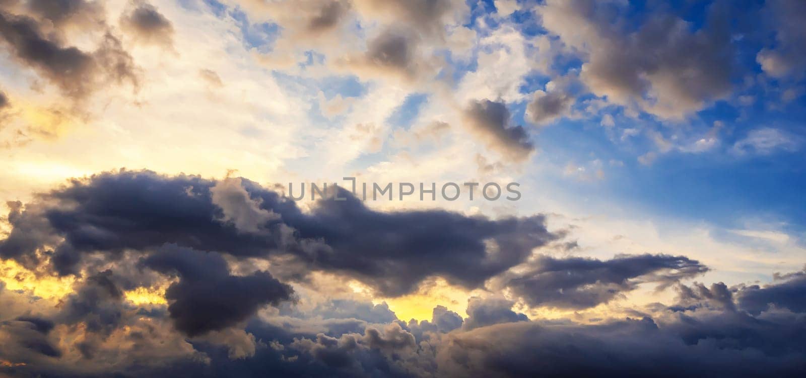 background with cloudy sky with clouds at sunset. Panorama of the orange-blue sky at sunrise