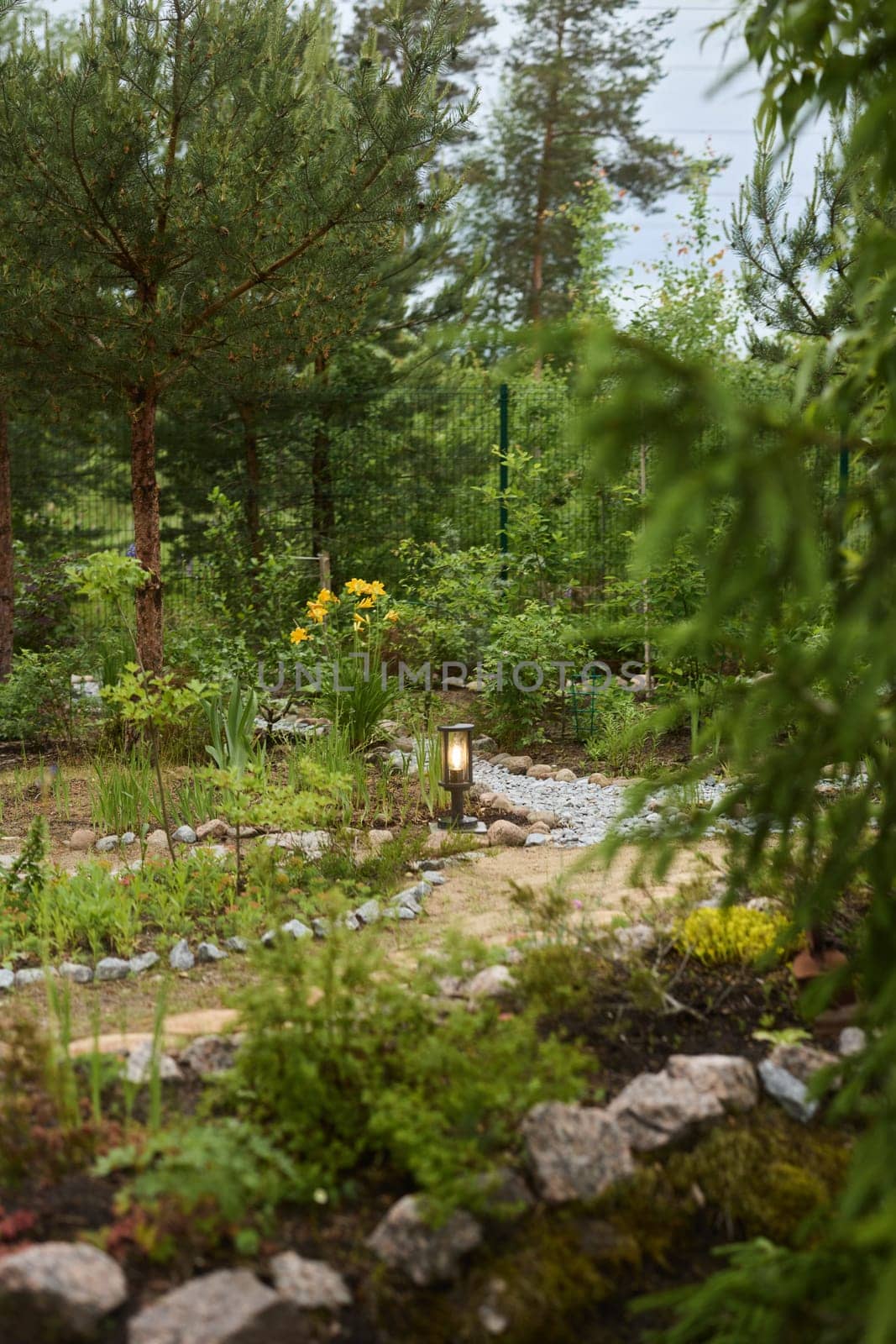 A peaceful and tranquil garden scene showcasing a winding path surrounded by vibrant flowers and lush greenery