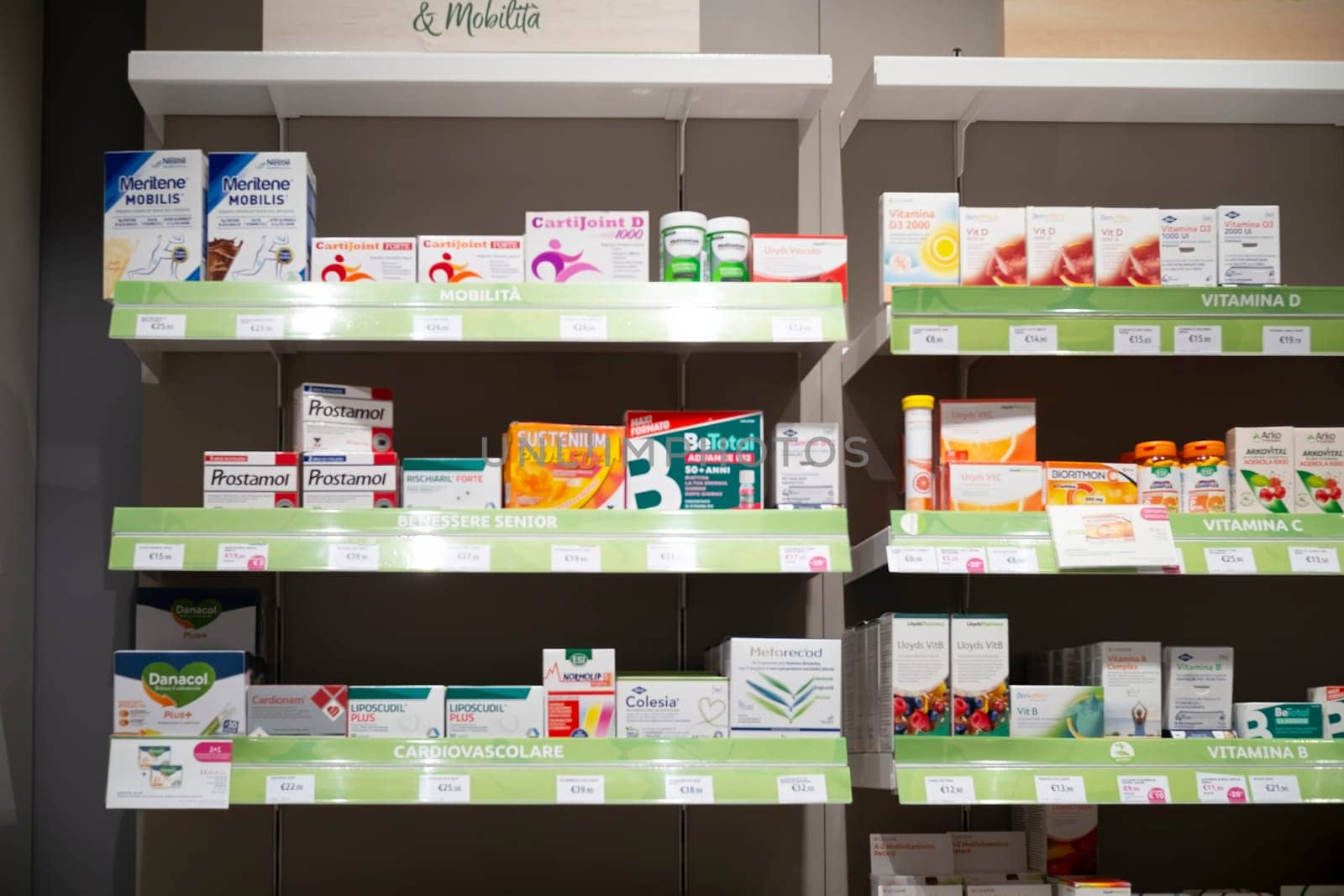 Cremona, Italy - November 20th 2024 Shelves stocked with a variety of medications and supplements in a pharmacy, offering healthcare solutions for different needs