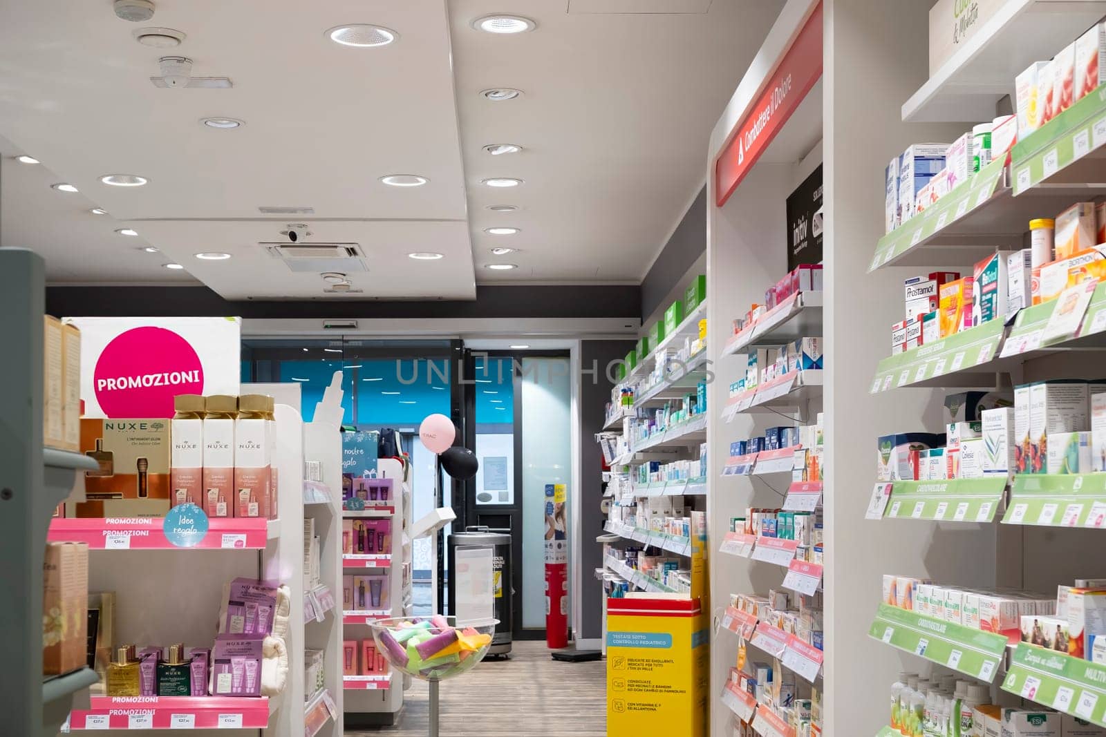 Cremona, Italy - November 20th 2024 Wide shot of a well-stocked pharmacy interior, showcasing a variety of healthcare products and promotions in cremona, italy