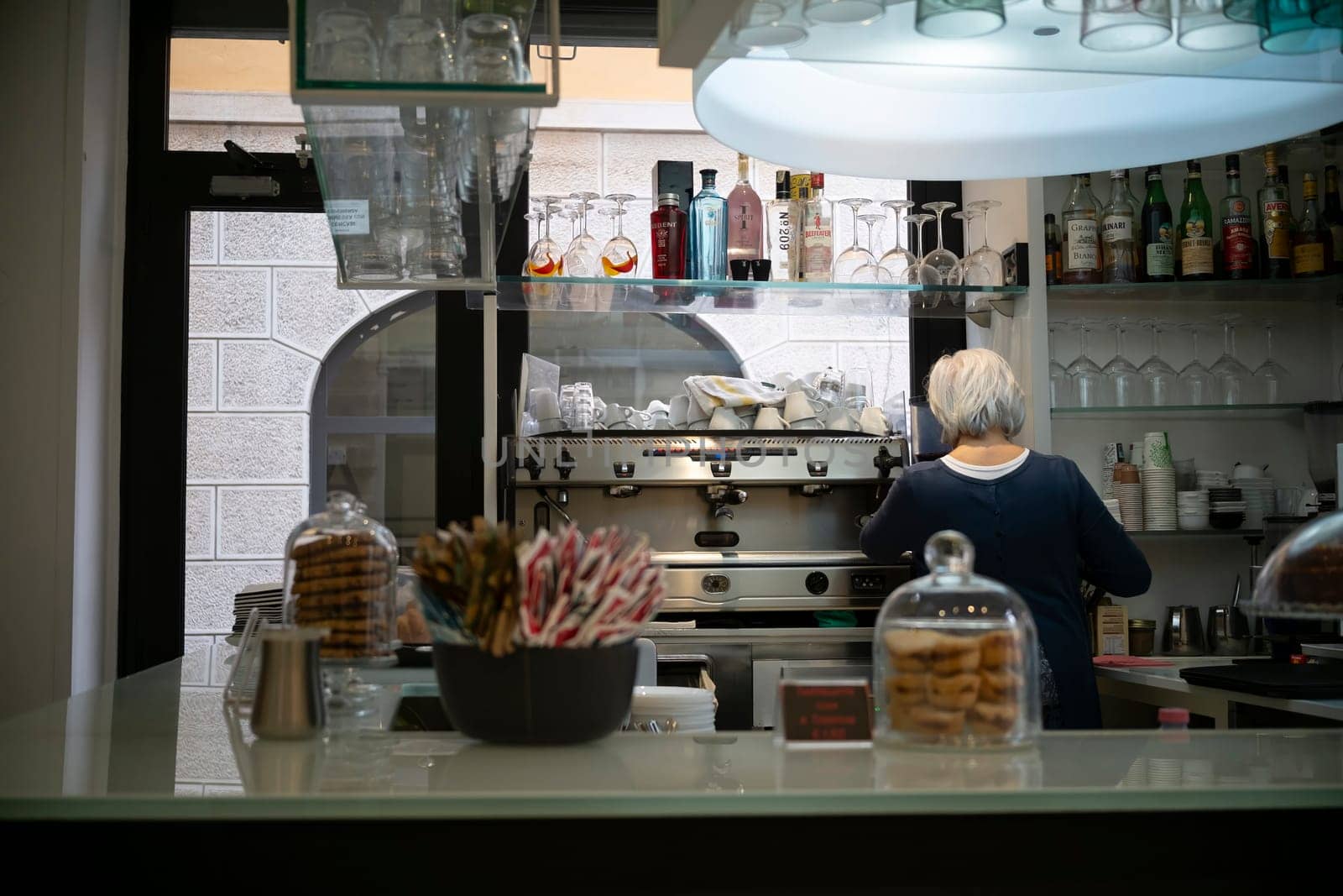 Cremona, Italy - November 20th 2024 Barista working at the counter of a typical italian cafe in cremona, preparing coffee with professional espresso machine