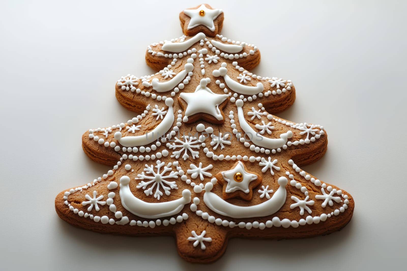Beautifully decorated gingerbread cookie shaped like a Christmas tree, perfect for festive occasions.