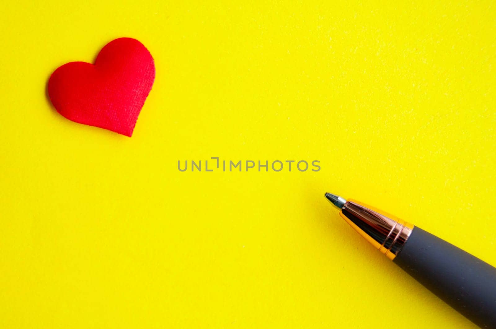 Heart shape and pen on yellow background cover with customizable space for text or message. Love concept and copy space.