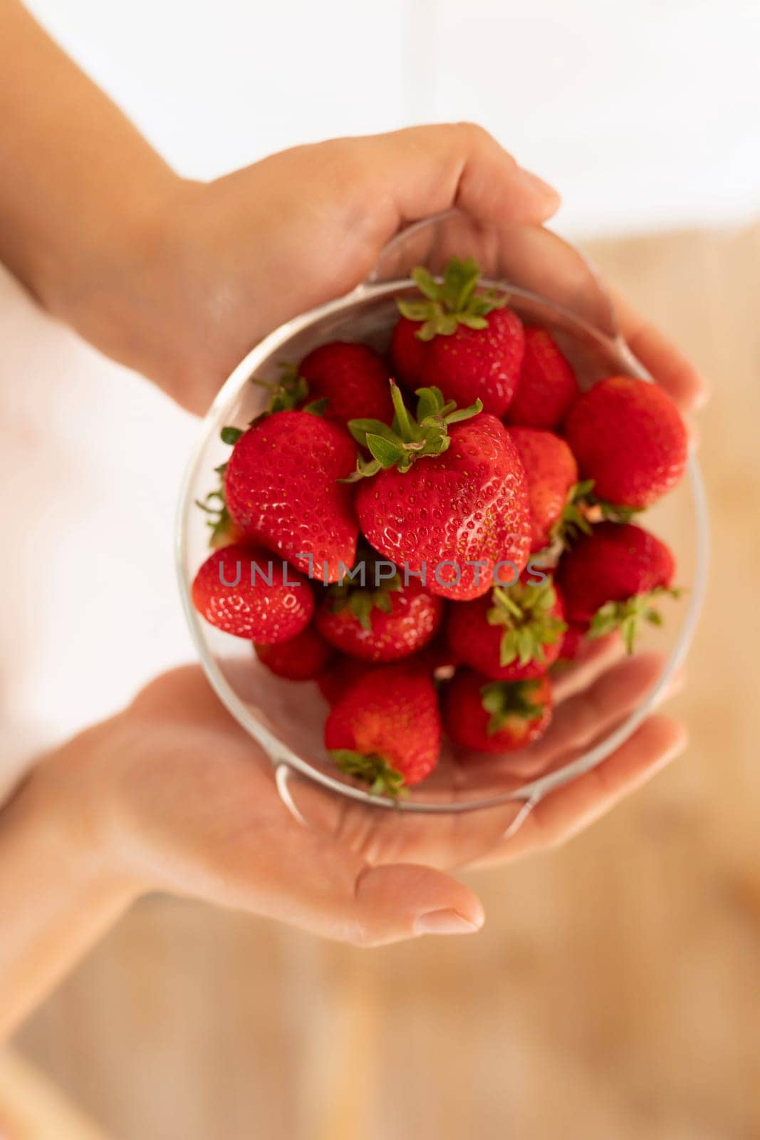 A close-up of fresh farm strawberries in hand.