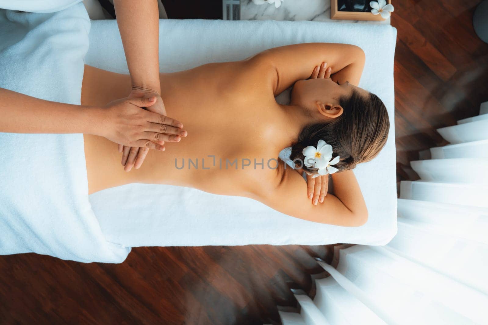 Panorama top view woman customer enjoying relaxing anti-stress spa massage and pampering with beauty skin recreation leisure in day light ambient salon spa at luxury resort or hotel. Quiescent