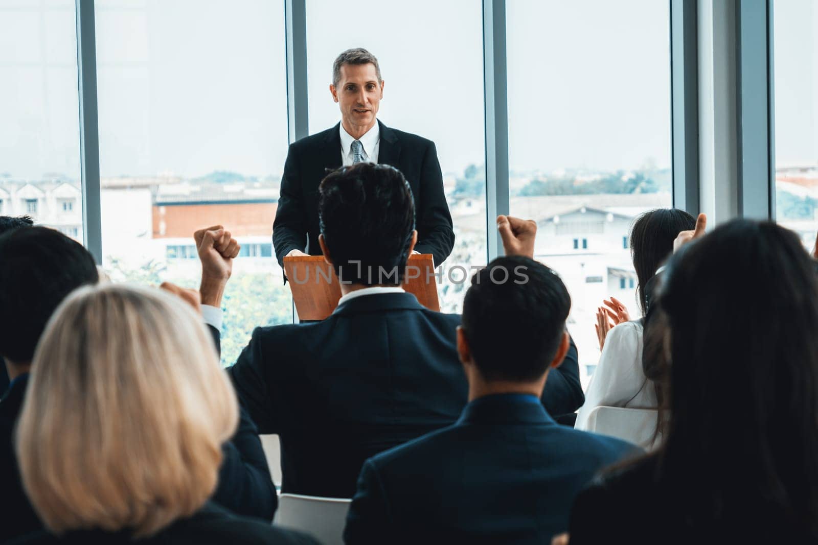 Group of business people meeting in a seminar conference . Audience listening to instructor in employee education training session . Office worker community summit forum with expert speaker . Jivy