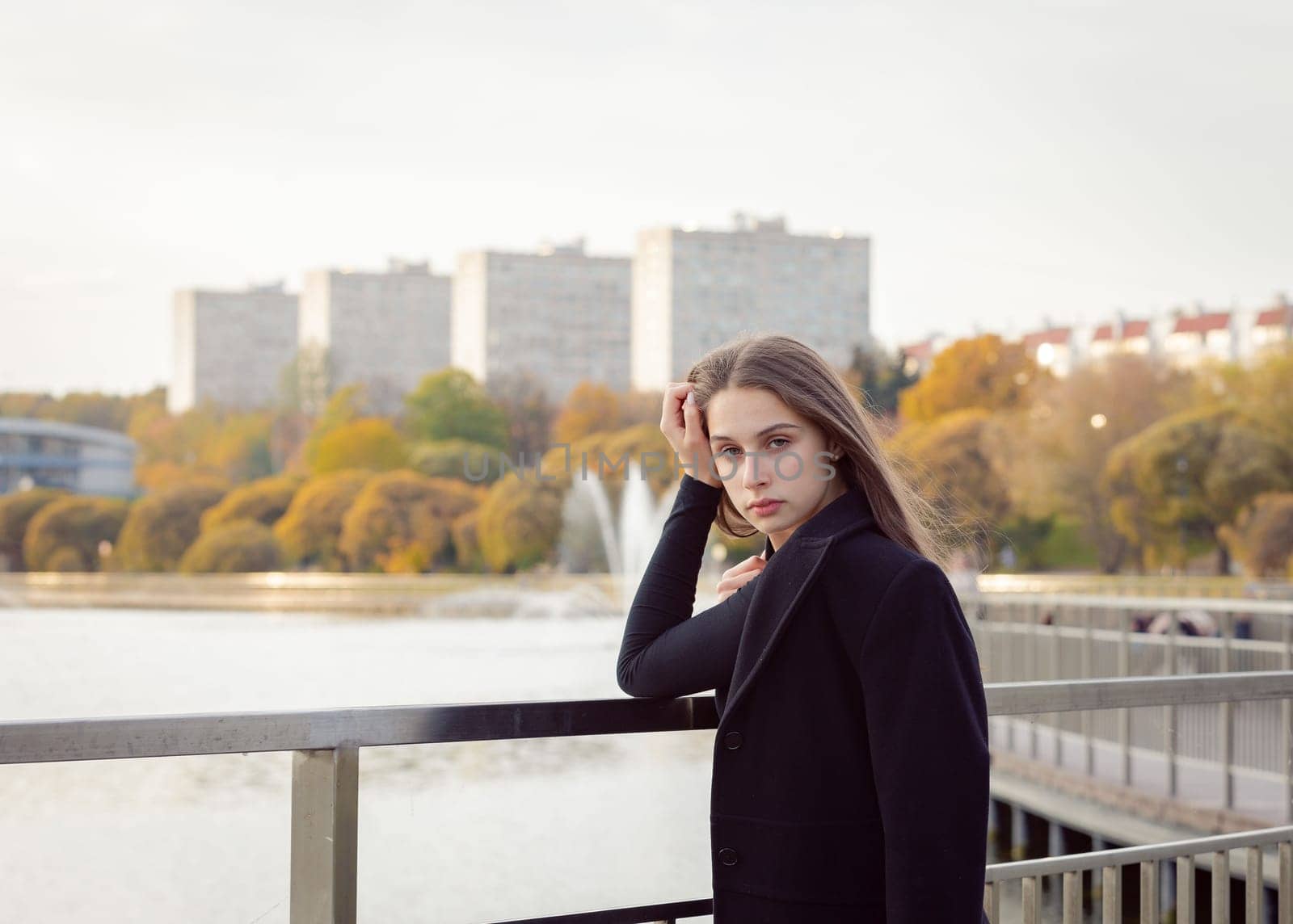 Portrait of a girl on a bridge near a pond in a city park. by Yurich32