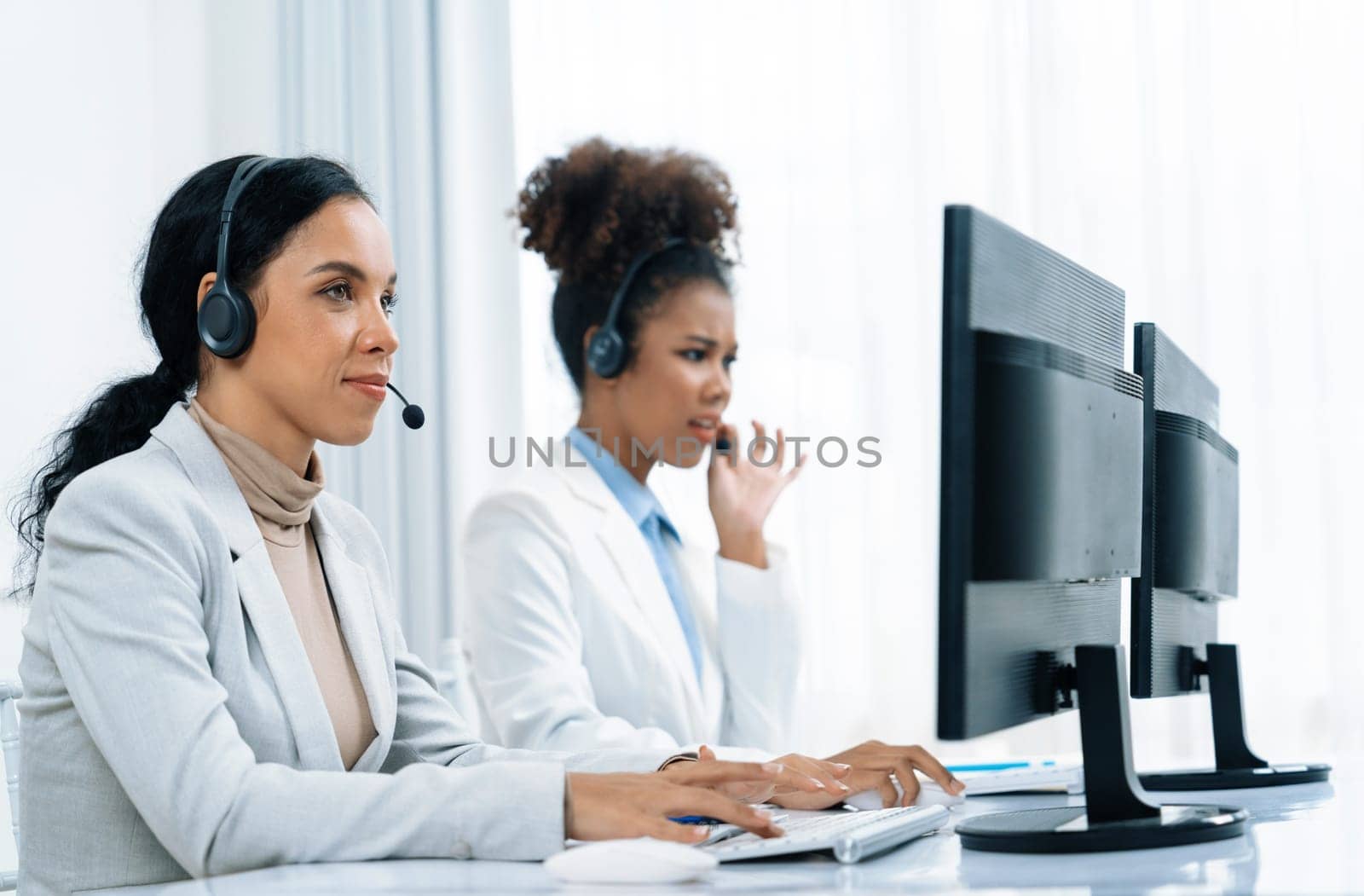 Business people wearing headset working in office to support remote customer or colleague. Call center, telemarketing, customer support agent provide service on telephone video conference call crucial