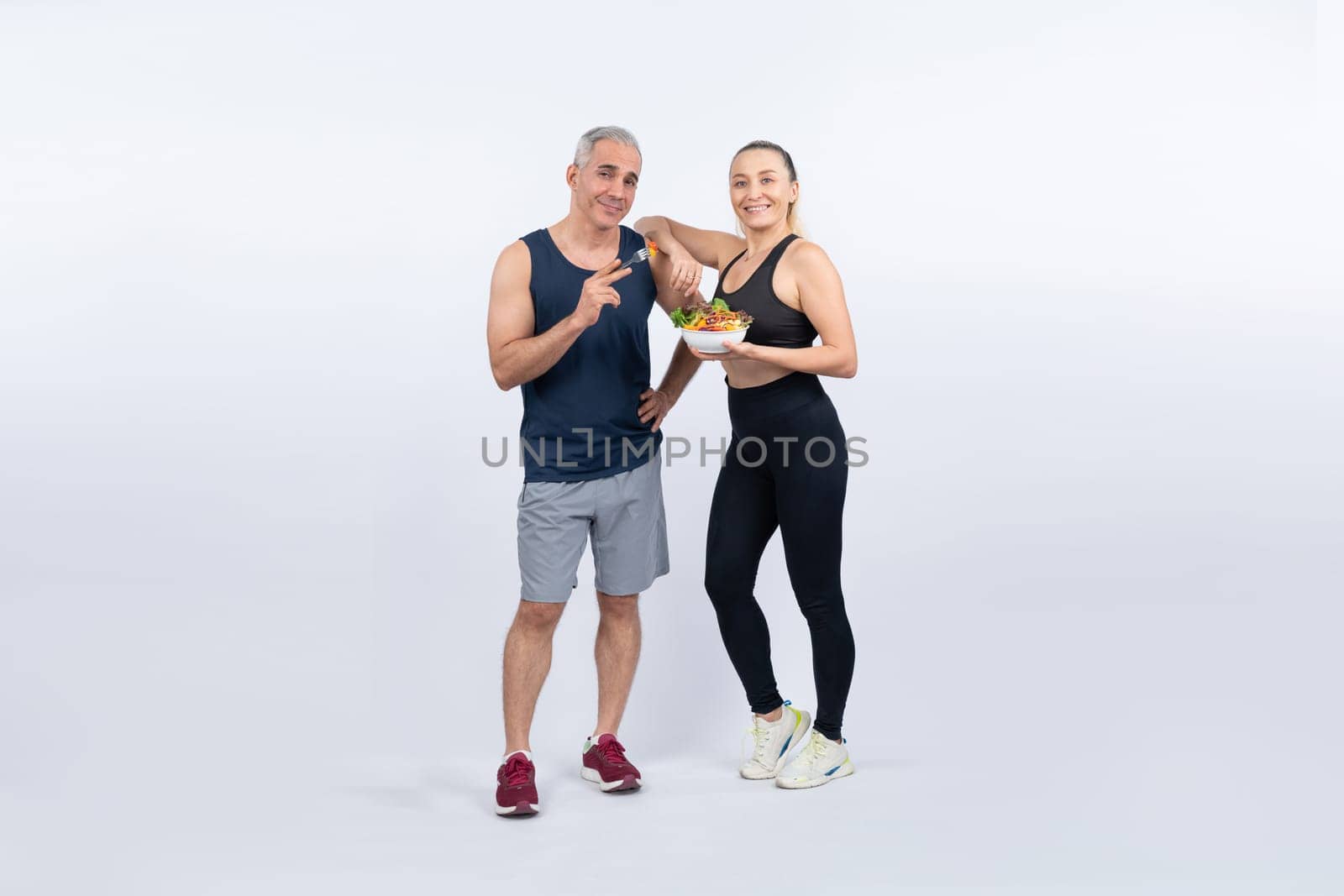 Happy smile senior man and woman portrait holding bowl of vegan. Clout by biancoblue