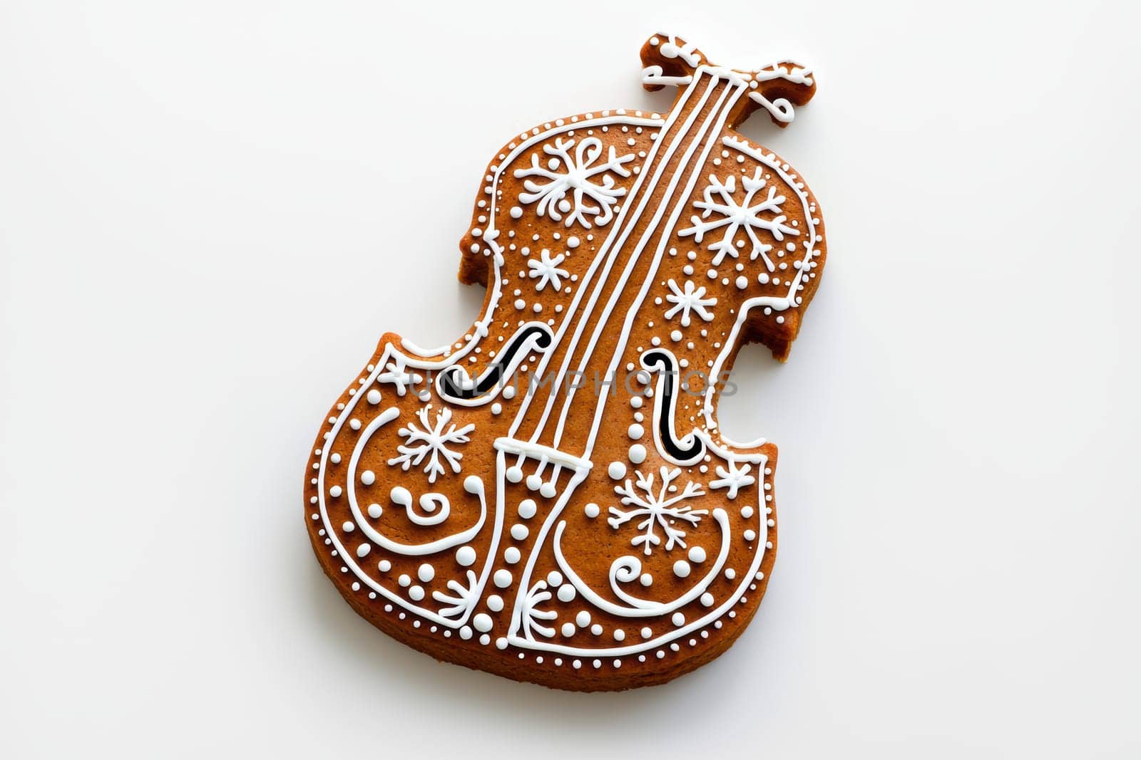 Charming gingerbread violin shaped cookie, beautifully decorated with white icing and festive designs.