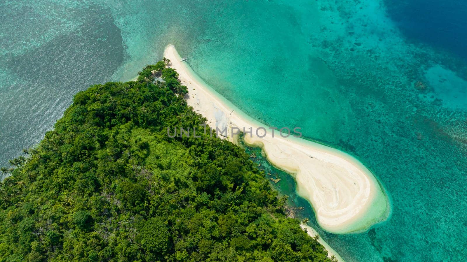 Aerial view of beautiful beach on a tropical island and blue sea. Agutaya island, Philippines.