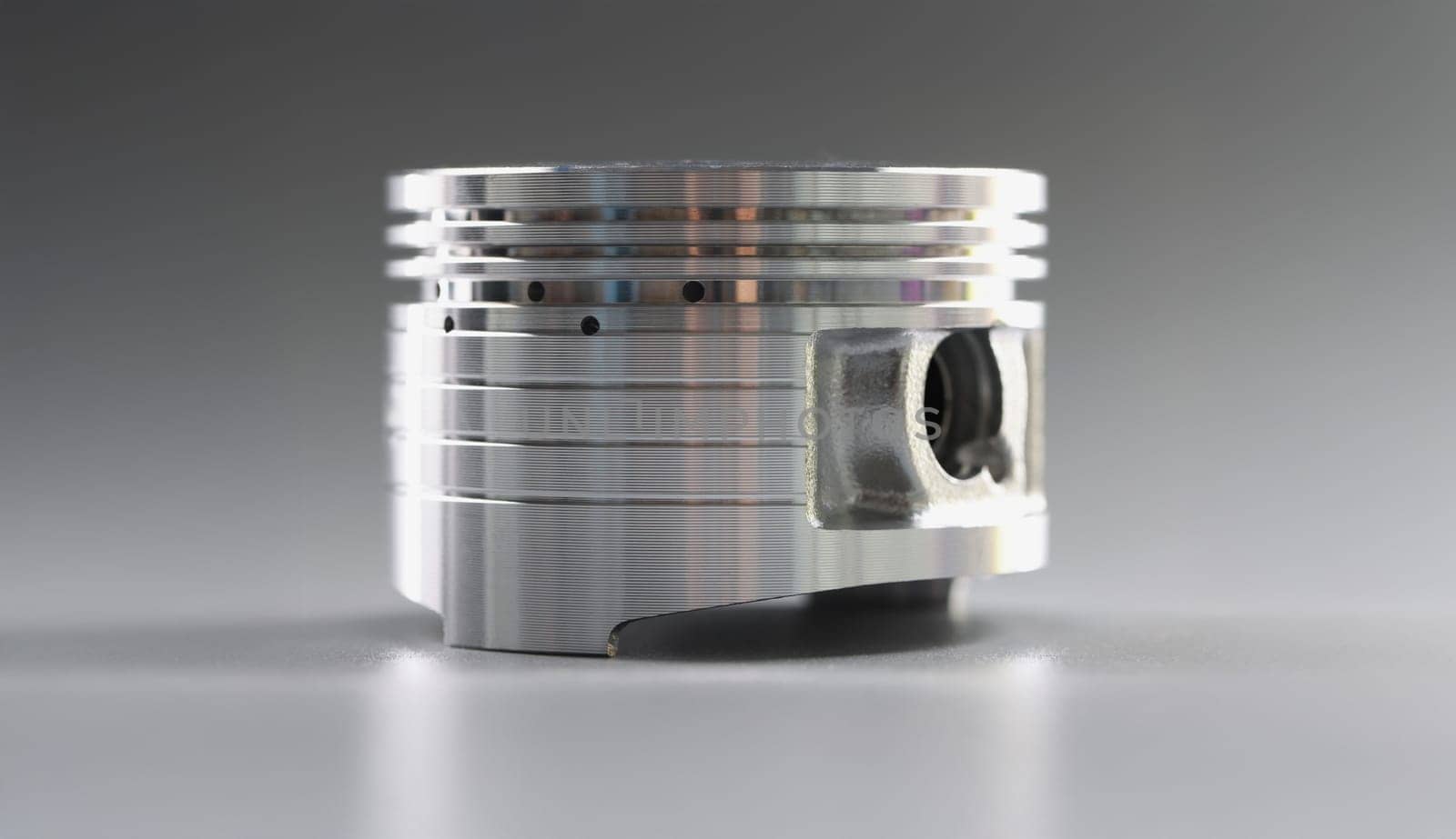 Car internal combustion piston, shiny new engine spare part, close-up. Motorcycle repair, auto upgrade, tuning