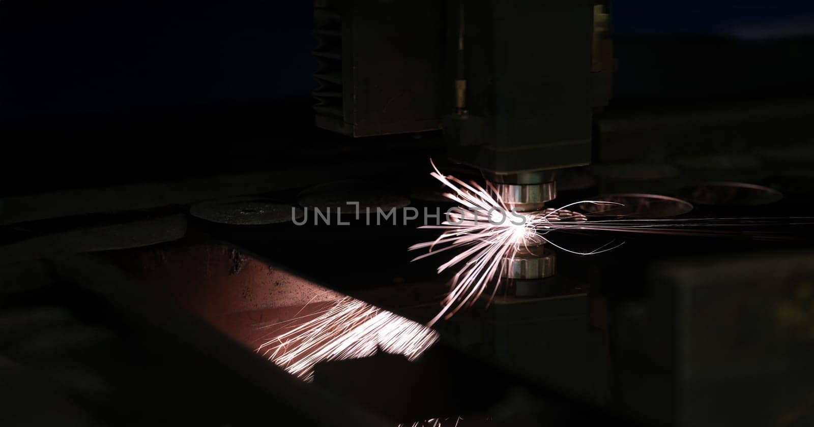 Bright sparks from metal turning, close-up. Laser cutting, mechanical engineering. Manufacturing complex parts