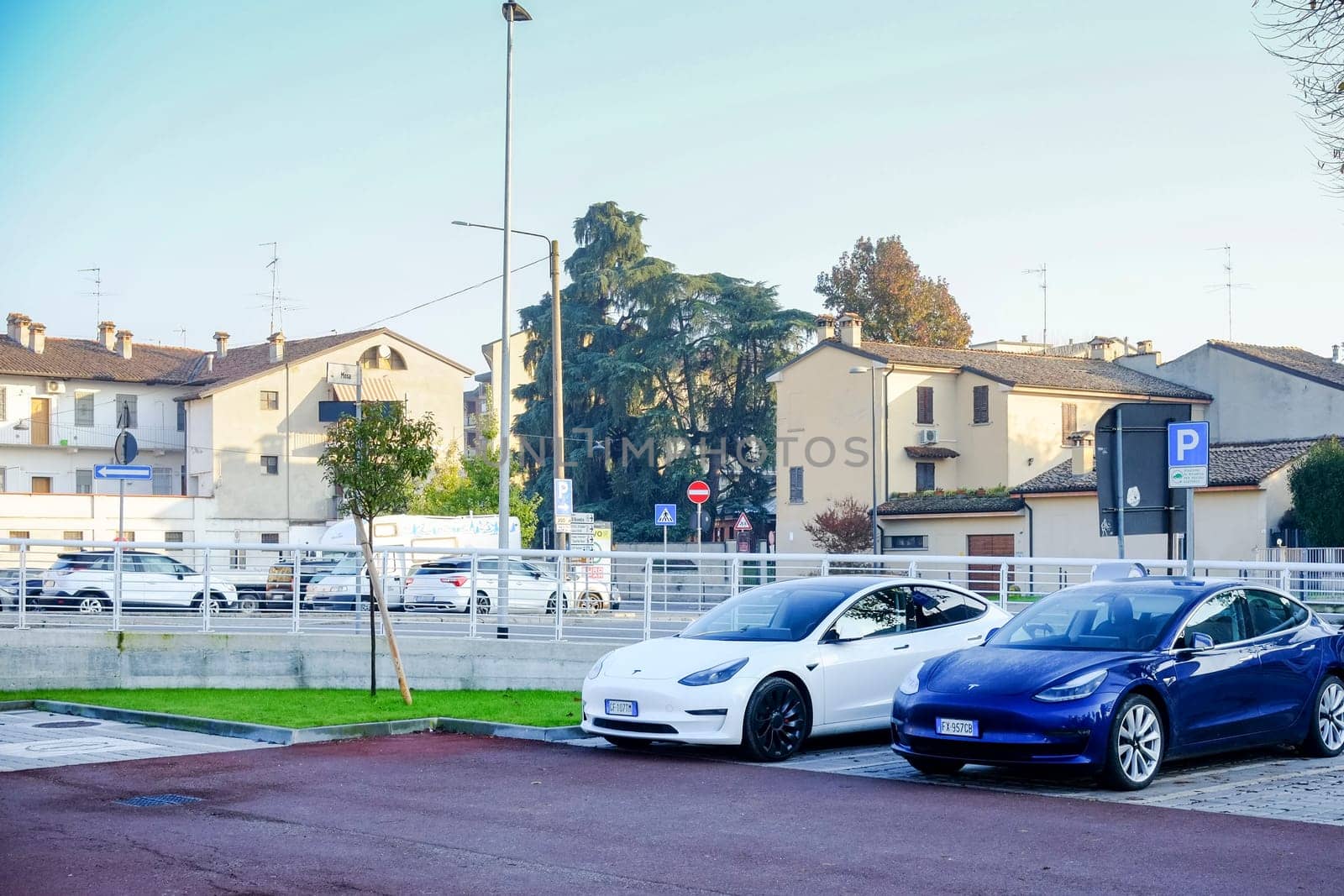 Cremona, Itally - October 6th 2024 Parked in a lot are white and blue tesla model 3 cars, featuring long range dual motor all-wheel drive
