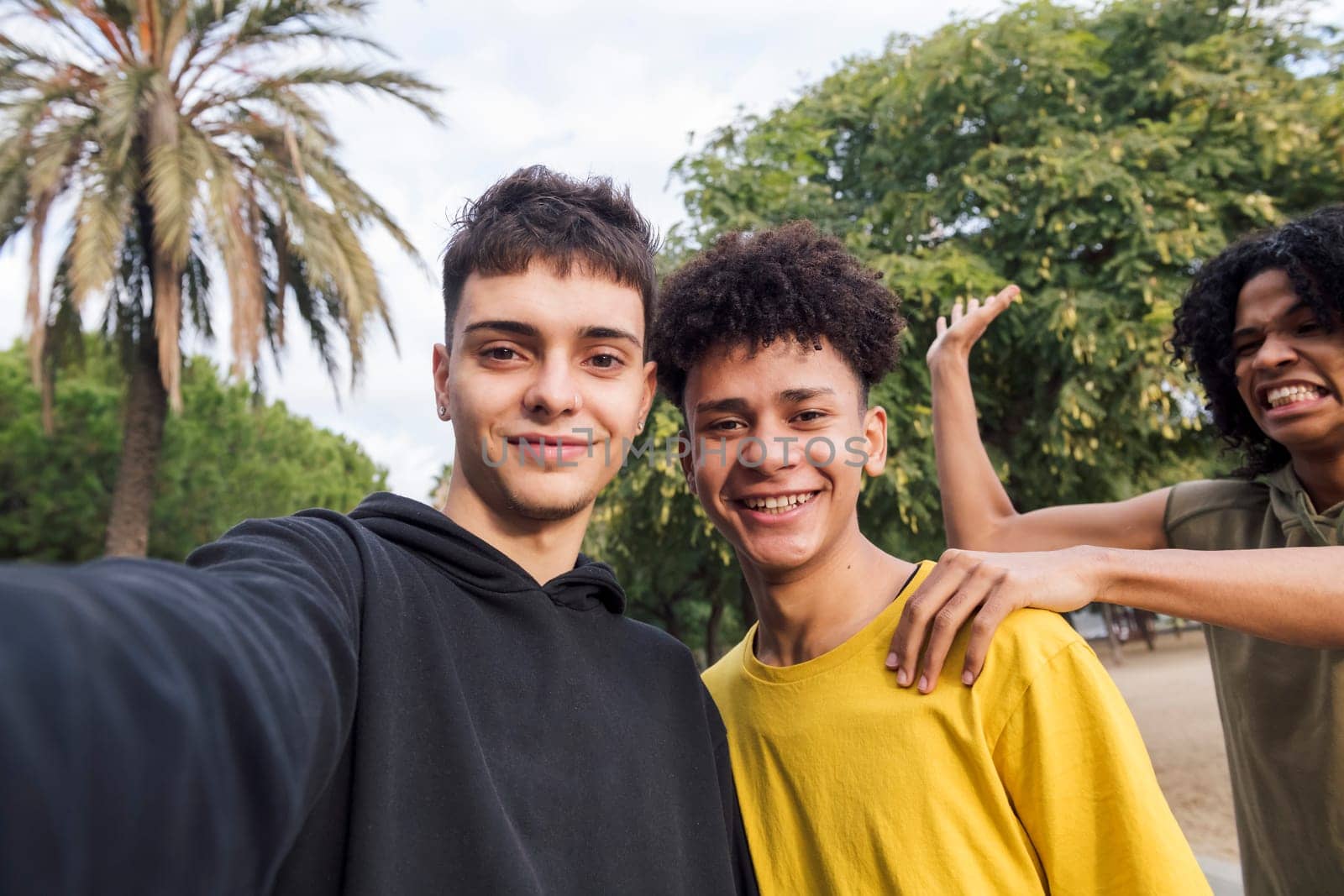 selfie photo of three multiethnic teenagers laughing happy and having fun, concept of youth lifestyle and technology of communication