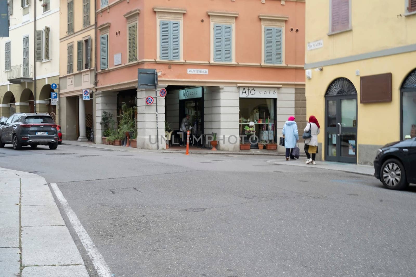 Cremona, Italy - November 20th 2024 Two women walking on via solferino crossing via stefano ceretti in cremona, italy