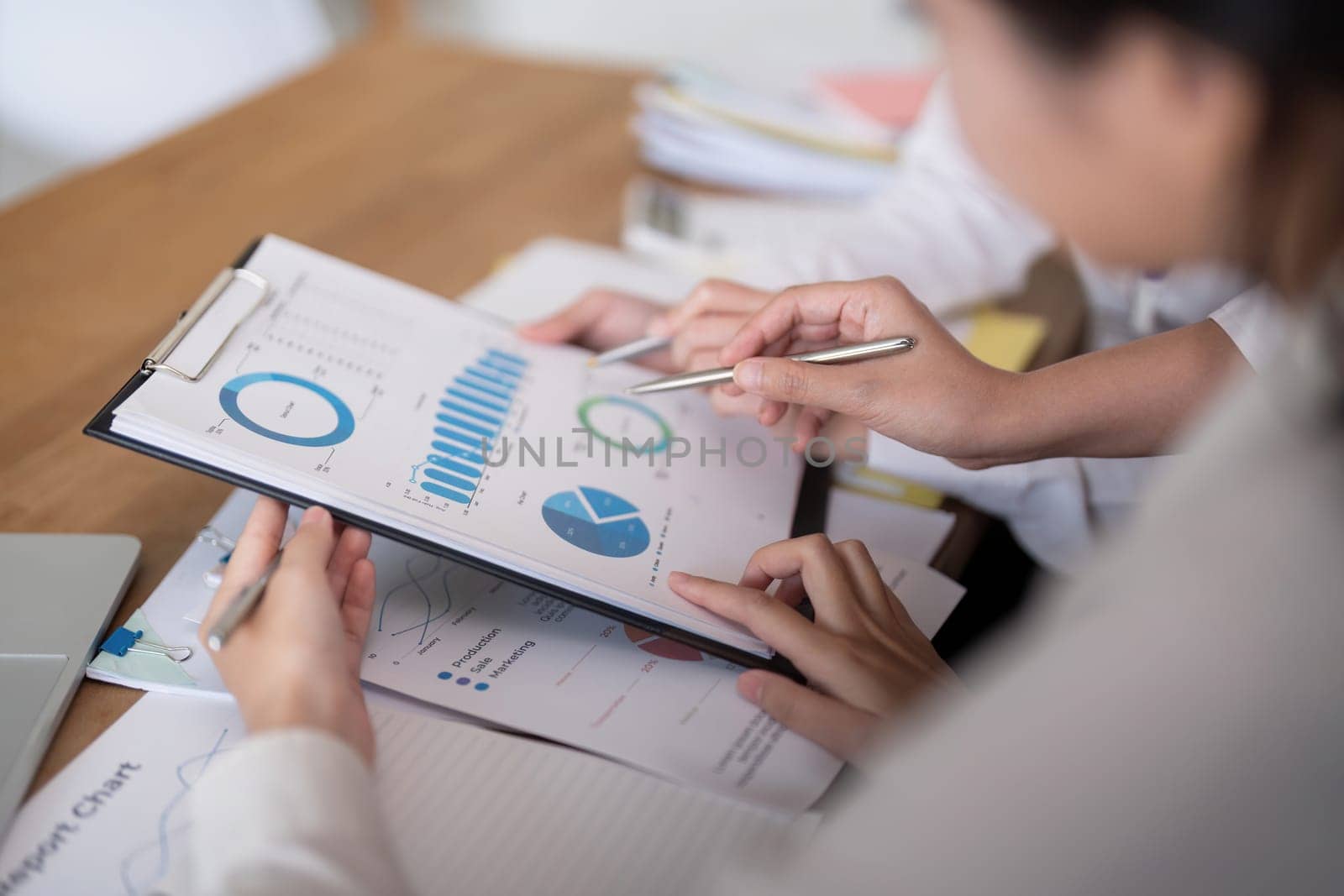 Business team analyzing income chart and graph in office. Close up. Business analysis and strategy concept.