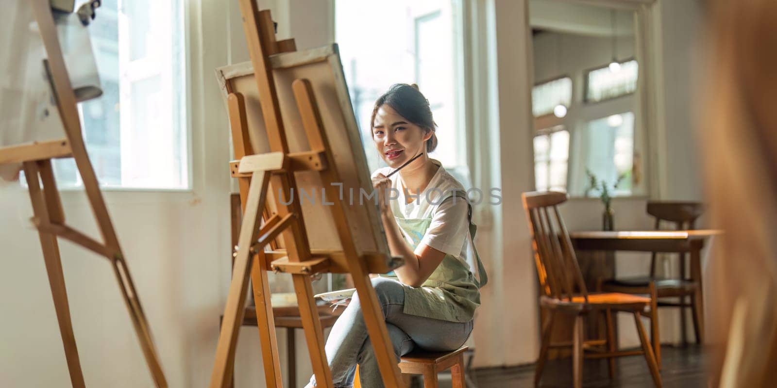 Talented Female Artist Working on a artist lifestyle. painting hobby. woman drawing beautiful watercolor design.