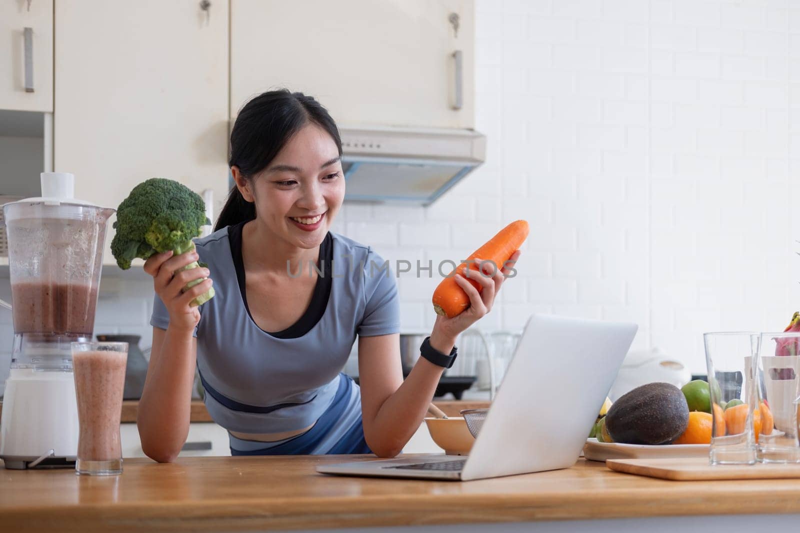 Young Asian healthy beautiful woman with casual clothes is smile and slicing fresh fruit to diet at home in kitchen in holiday.