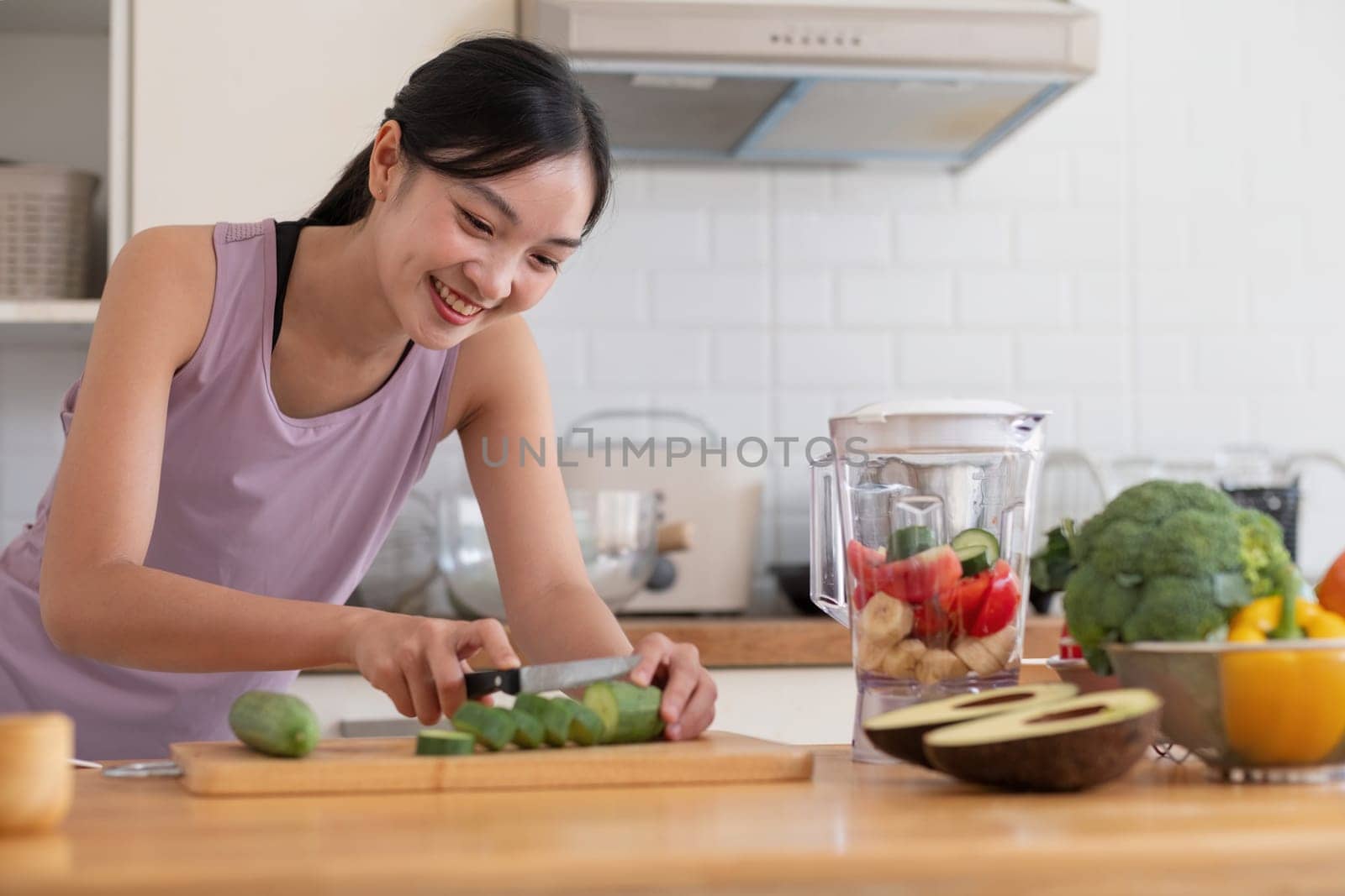 Young Asian healthy beautiful woman with casual clothes is smile and slicing fresh fruit to diet at home in kitchen in holiday.