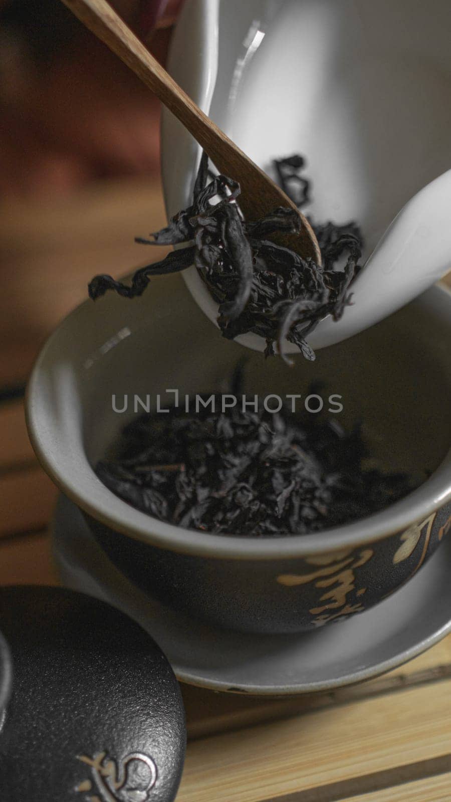 In this serene moment, loose leaf tea is being prepared, beautifully highlighting the elegant, delicate brewing process